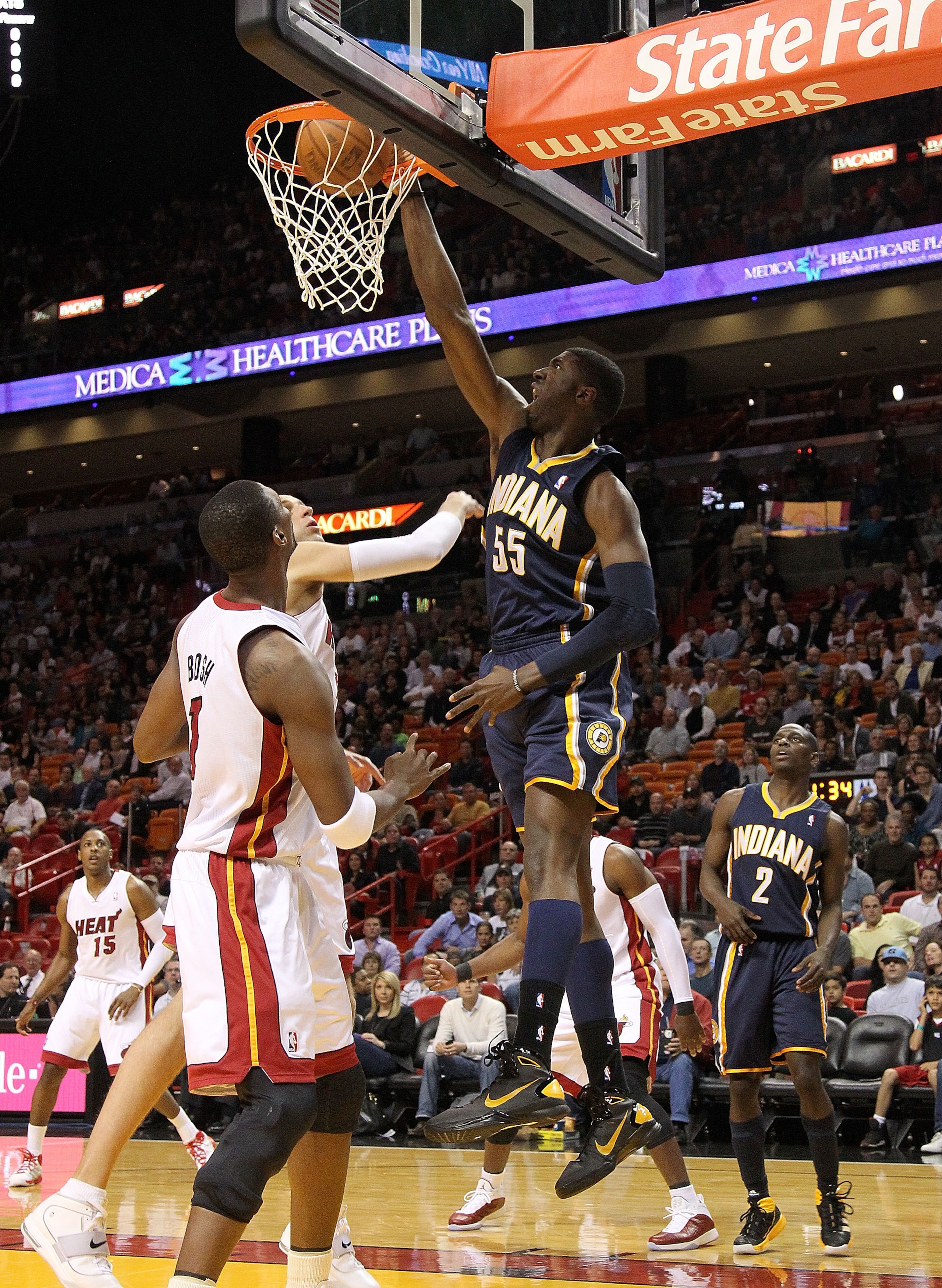 MIAMI, FL - FEBRUARY 08: Roy Hibbert #55 of the Indiana Pacers shoots over Chris Bosh #1 of the Miami Heat during a game at American Airlines Arena on February 8, 2011 in Miami, Florida. NOTE TO USER: User expressly acknowledges and agrees that, by downlo