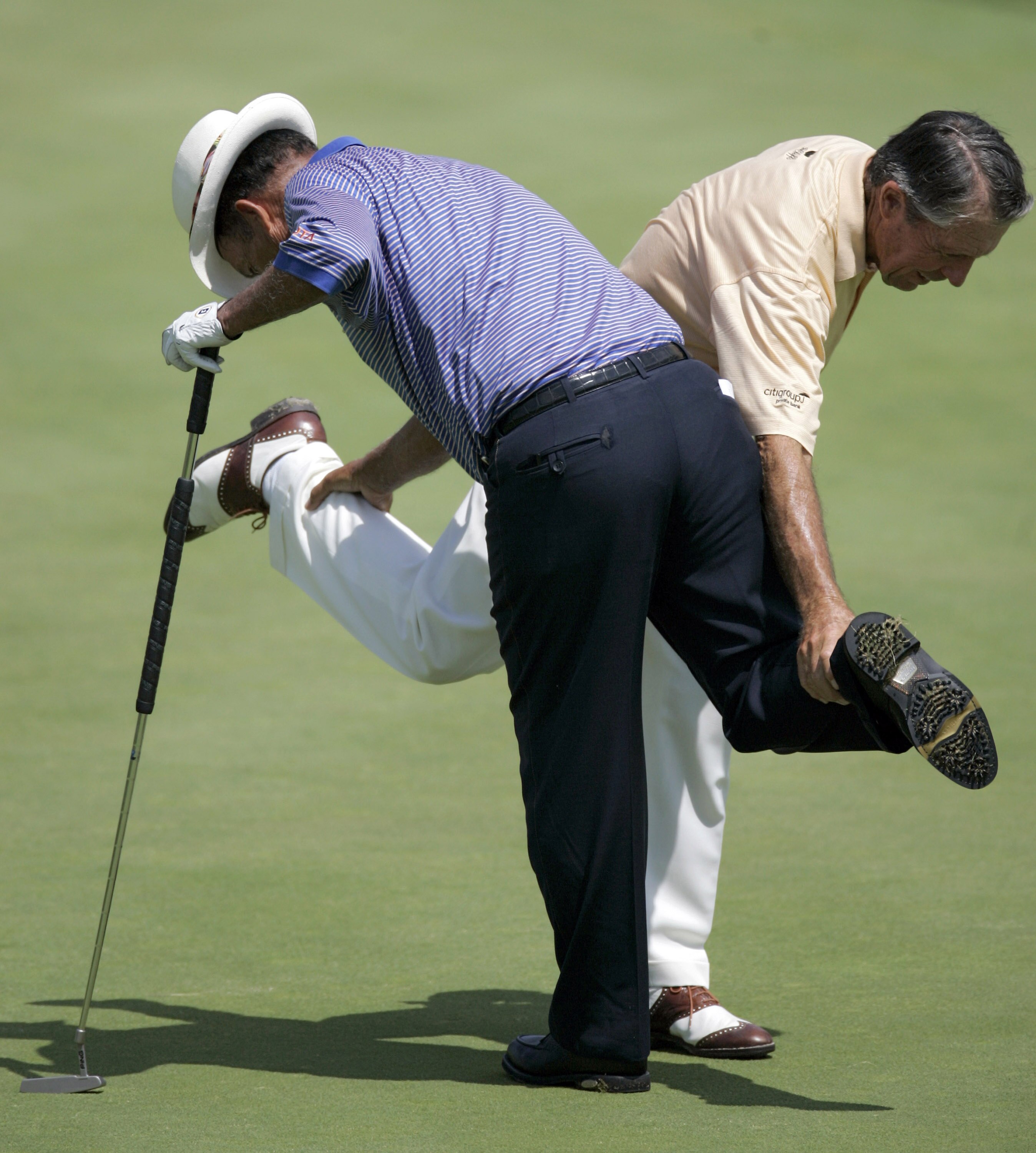 UNITED STATES - JULY 13:  Chi Chi Rodriguez and Gary Player during the first round of the Ford Senior Players Championship held at TPC Michigan in Dearborn, Michigan, on July 13, 2006.  (Photo by Gregory Shamus/Getty Images)