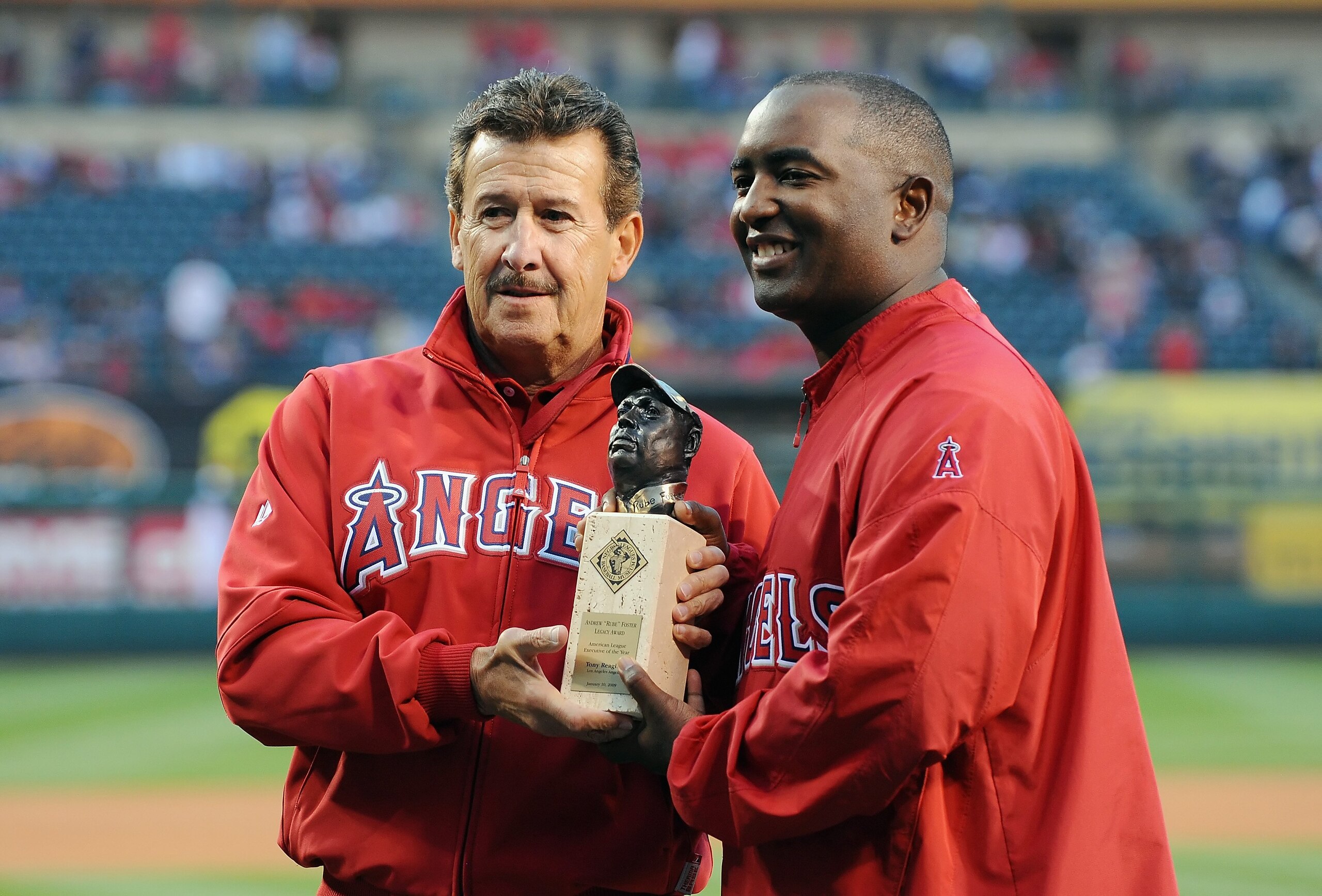 ANAHEIM, CA - APRIL 07:  Owner of the Los Angeles Angels of Anaheim Arturo Moreno presents Tony Reagins with the Andrew Foster Legacy Award before the game against the Oakland Athletics on April 7, 2009 in Anaheim, California.  (Photo by Lisa Blumenfeld/G