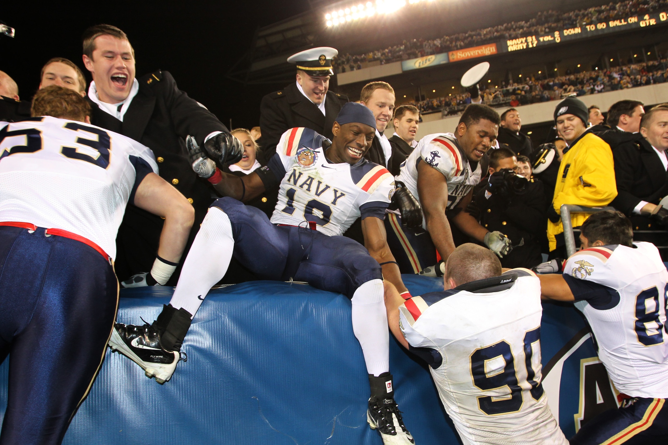 PHILADELPHIA - DECEMBER 11: Linebacker Jarred Shannon #10 of the Navy Midshipmen jumps into the stands after a game against the Army Black Knights on December 11, 2010 at Lincoln Financial Field in Philadelphia, Pennsylvania. The Midshipmen won 31-17. (Ph PHILADELPHIA - DECEMBER 11: Linebacker Jarred Shannon #10 of the Navy Midshipmen jumps into the stands after a game against the Army Black Knights on December 11, 2010 at Lincoln Financial Field in Philadelphia, Pennsylvania. The Midshipmen won 31-17. (Ph