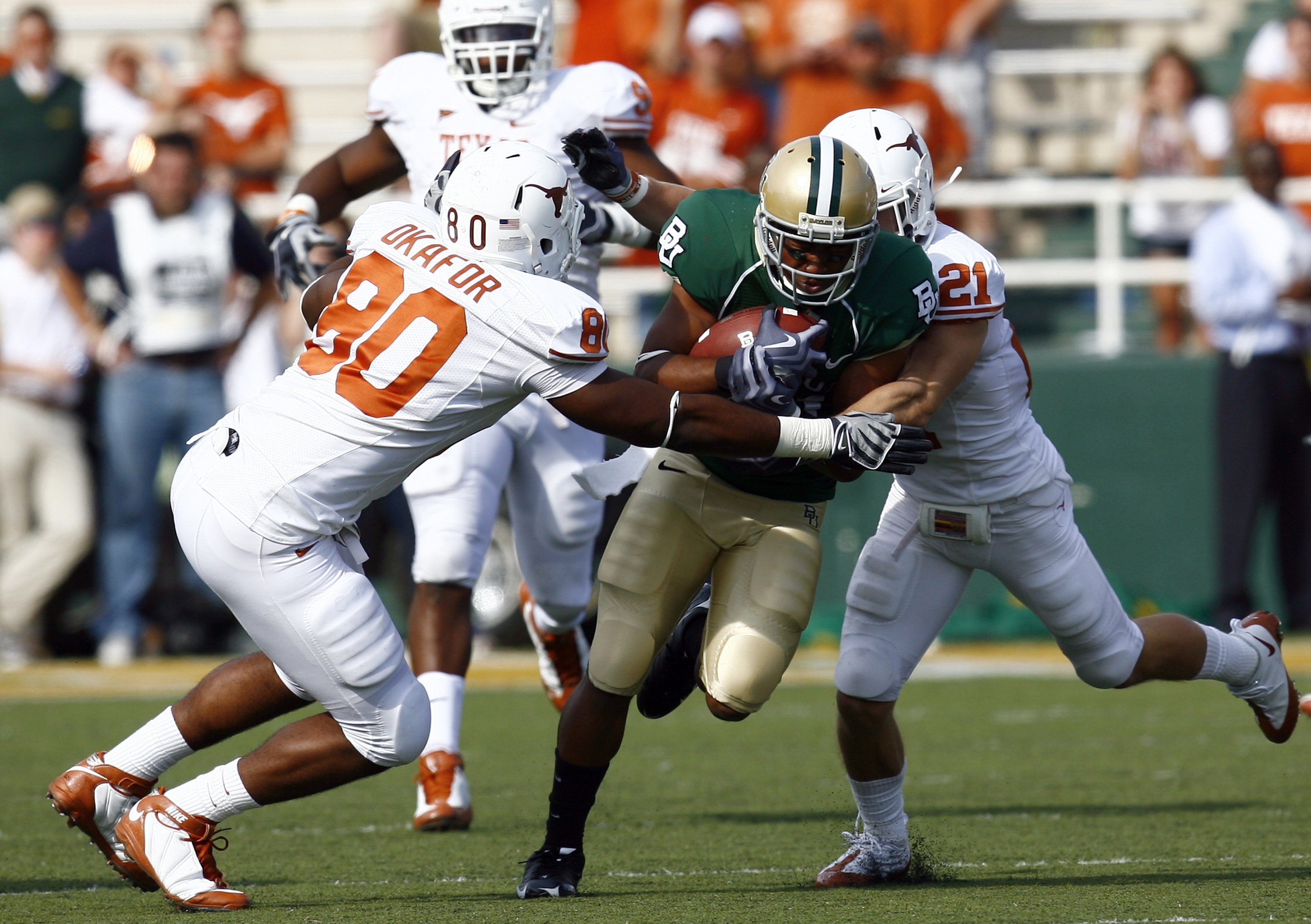 WACO, TX - NOVEMBER 14:  Running back Jarred Salubi #21 of the Baylor Bears carries the ball during in the second half against defensive end Alex Okafor #80 and safety Blake Gideon #21 of the Texas Longhorns on November 14, 2009 at Floyd Casey Stadium in