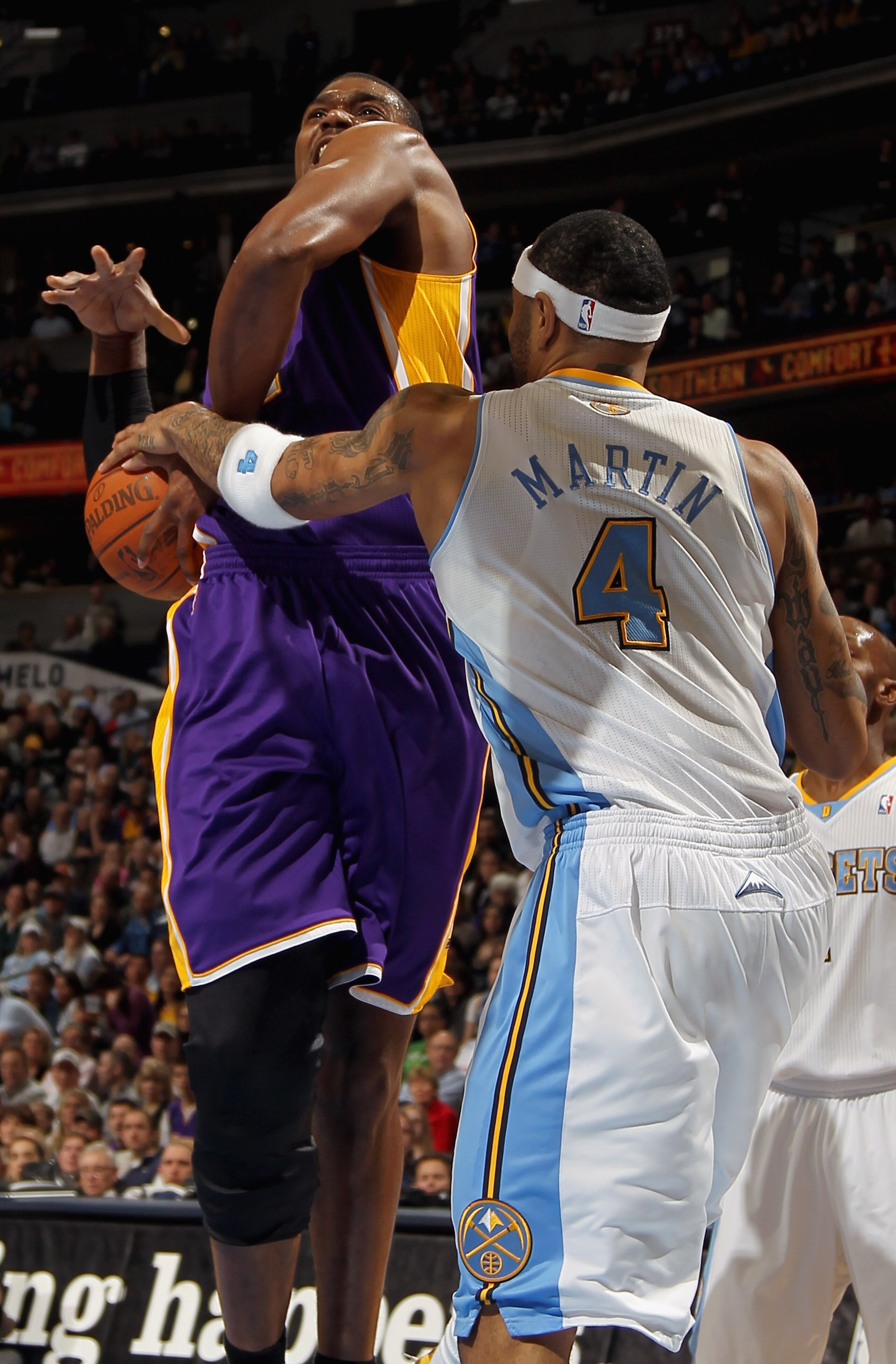 DENVER, CO - JANUARY 21:  Andrew Bynum #17 of the Los Angeles Lakers is fouled by Kenyon Martin #4 of the Denver Nuggets at the Pepsi Center on January 21, 2011 in Denver, Colorado. NOTE TO USER: User expressly acknowledges and agrees that, by downloading