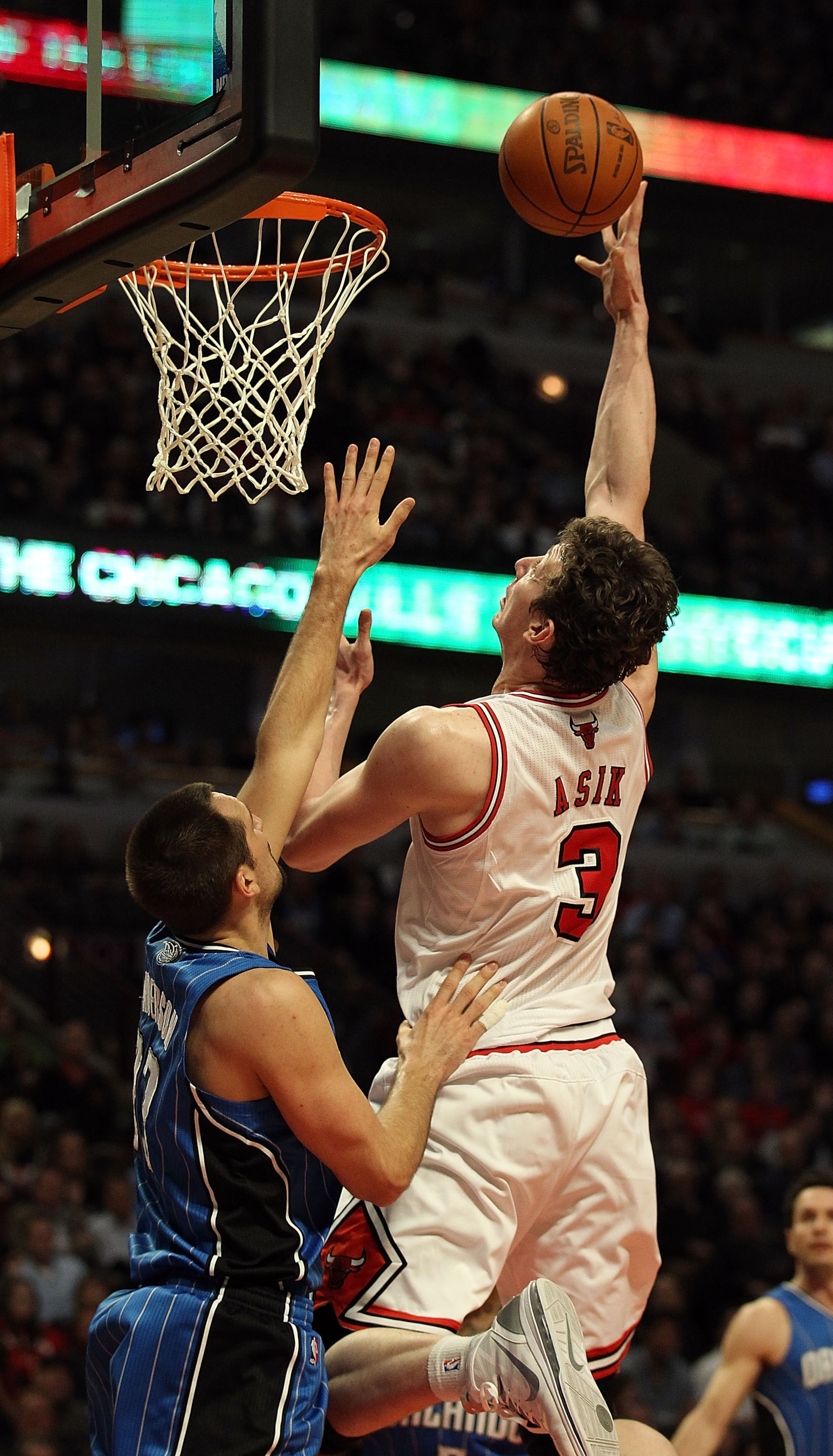 CHICAGO, IL - JANUARY 28: Omer Asik #3 of the Chicago Bulls puts up a shot over Ryan Anderson #33 of the Orlando Magic at the United Center on January 28, 2011 in Chicago, Illinois. The Bulls defeated the Magic 99-90. NOTE TO USER: User expressly acknowle