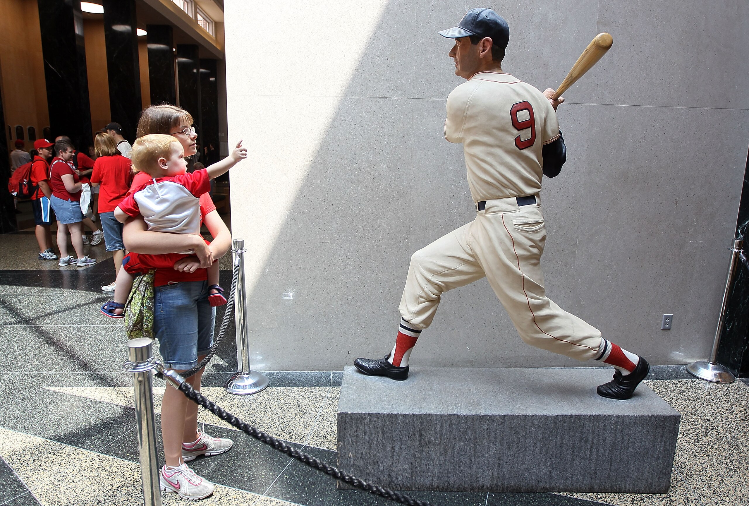 COOPERSTOWN, NY - JULY 24:  Patrons of the Baseball Hall Of Fame and Museum view a statue of Ted Williams during induction weekend on July 24, 2010 in Cooperstown, New York.  (Photo by Jim McIsaac/Getty Images)
