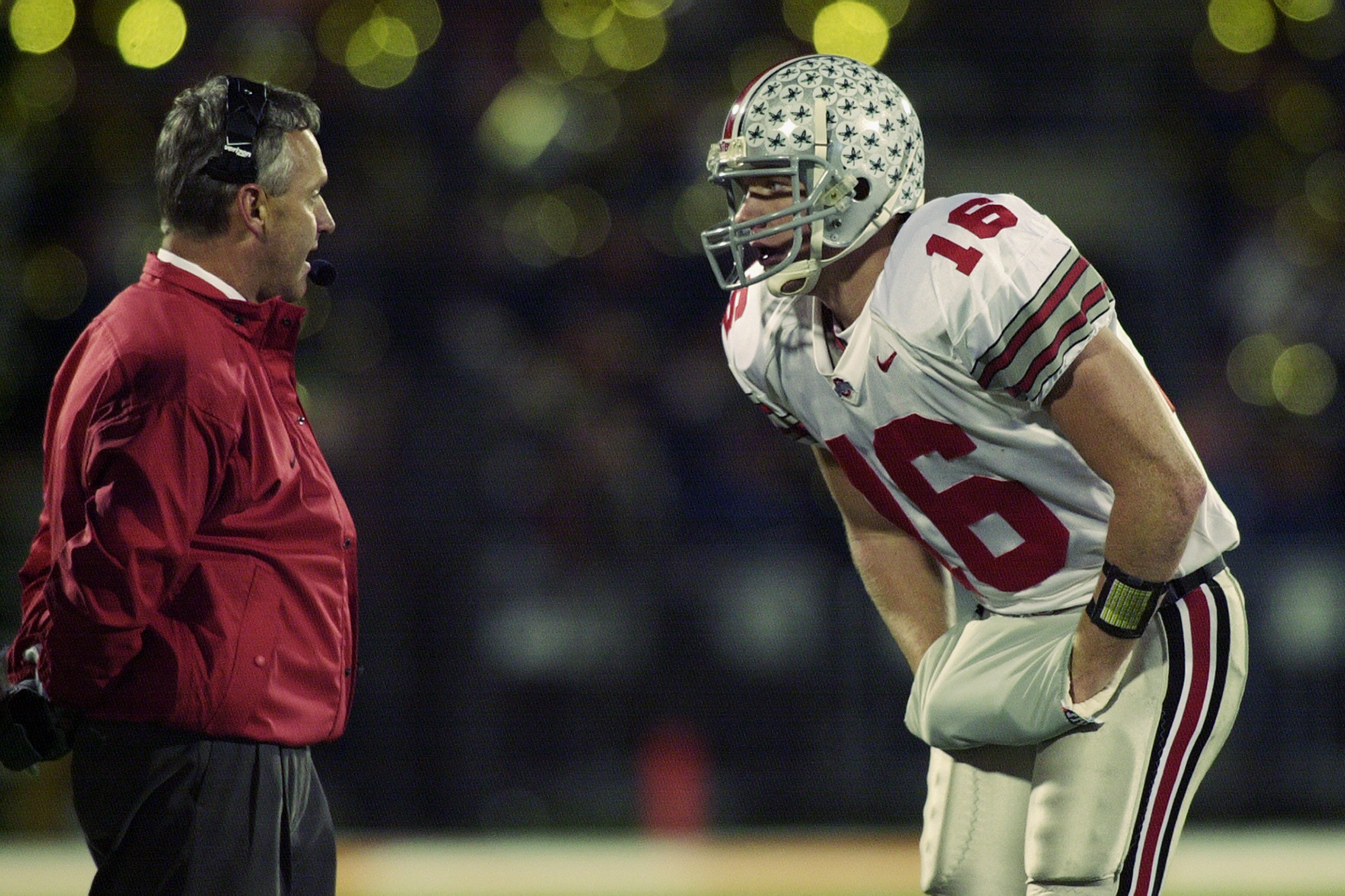 CHAMPAIGN, IL - NOVEMBER 16:  Head coach Jim Tressel of the Ohio State Buckeyes talks to his quarterback Craig Krenzel #16 talk during the Big Ten game against the University of Illinois Fighting Illini at Memorial Stadium on November 16, 2002 in Champaig