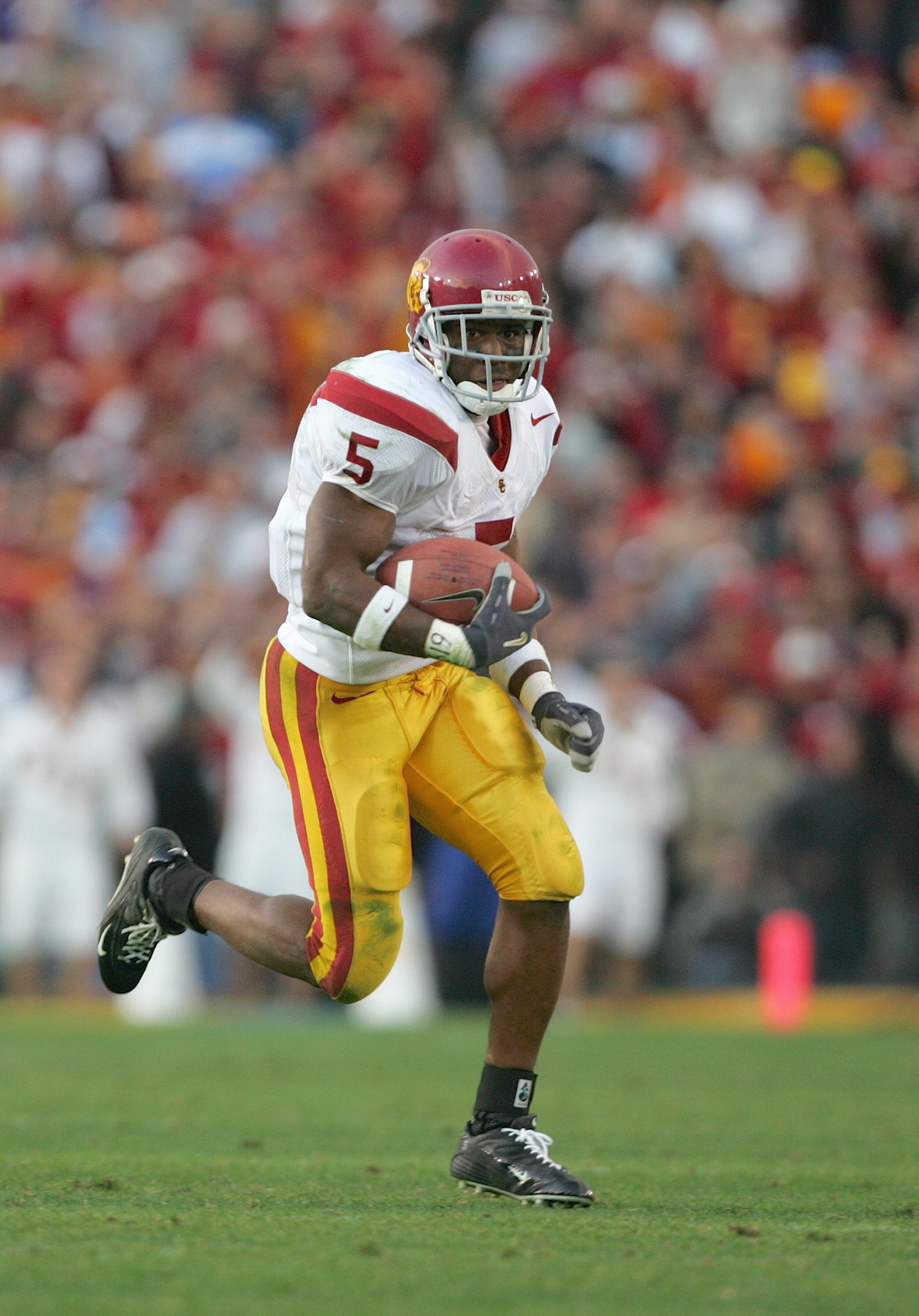 PASADENA, CA - DECEMBER 4:  Reggie Bush #5 of the USC Trojans carries the ball during the game against the UCLA Bruins on December 4, 2004 at the Rose Bowl in Pasadena, California.  USC won 29-24. (Photo by Harry How/Getty Images)