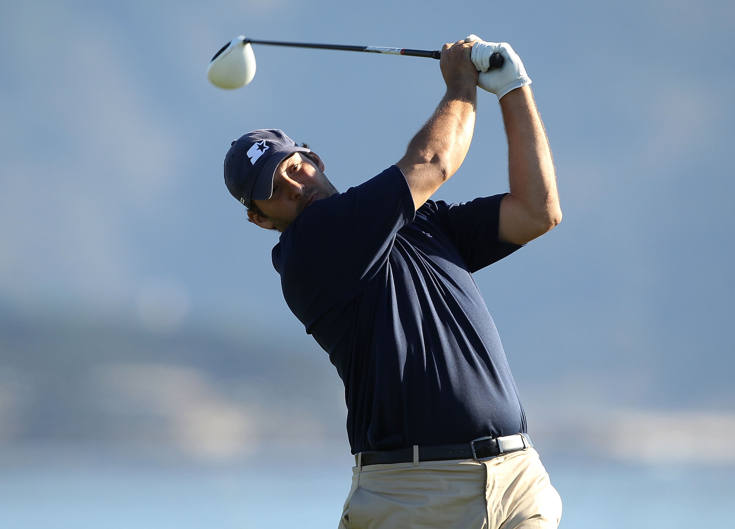 PEBBLE BEACH, CA - FEBRUARY 12:  Professional football player Tony Romo tees off on the 18th hole during the third round of the AT&T Pebble Beach National Pro-Am at the Pebble Beach Golf Links on February 12, 2011 in Pebble Beach, California.  (Photo by E