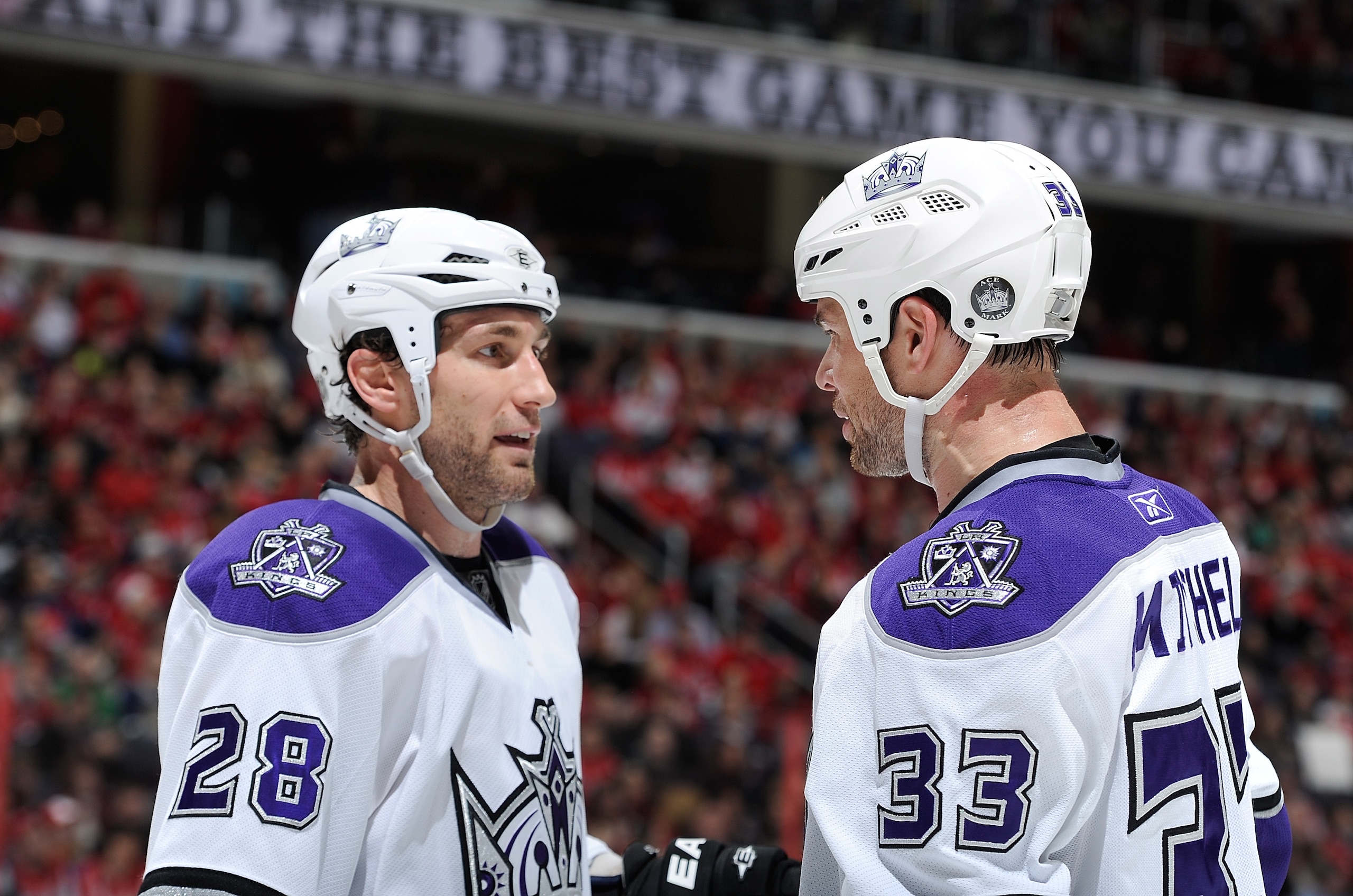 WASHINGTON, DC - FEBRUARY 12:  Jarret Stoll #28 of the Los Angeles Kings talks with teammate Willie Mitchell #33 during a break in the game against the Washington Capitals at the Verizon Center on February 12, 2011 in Washington, DC.  The Kings won the ga
