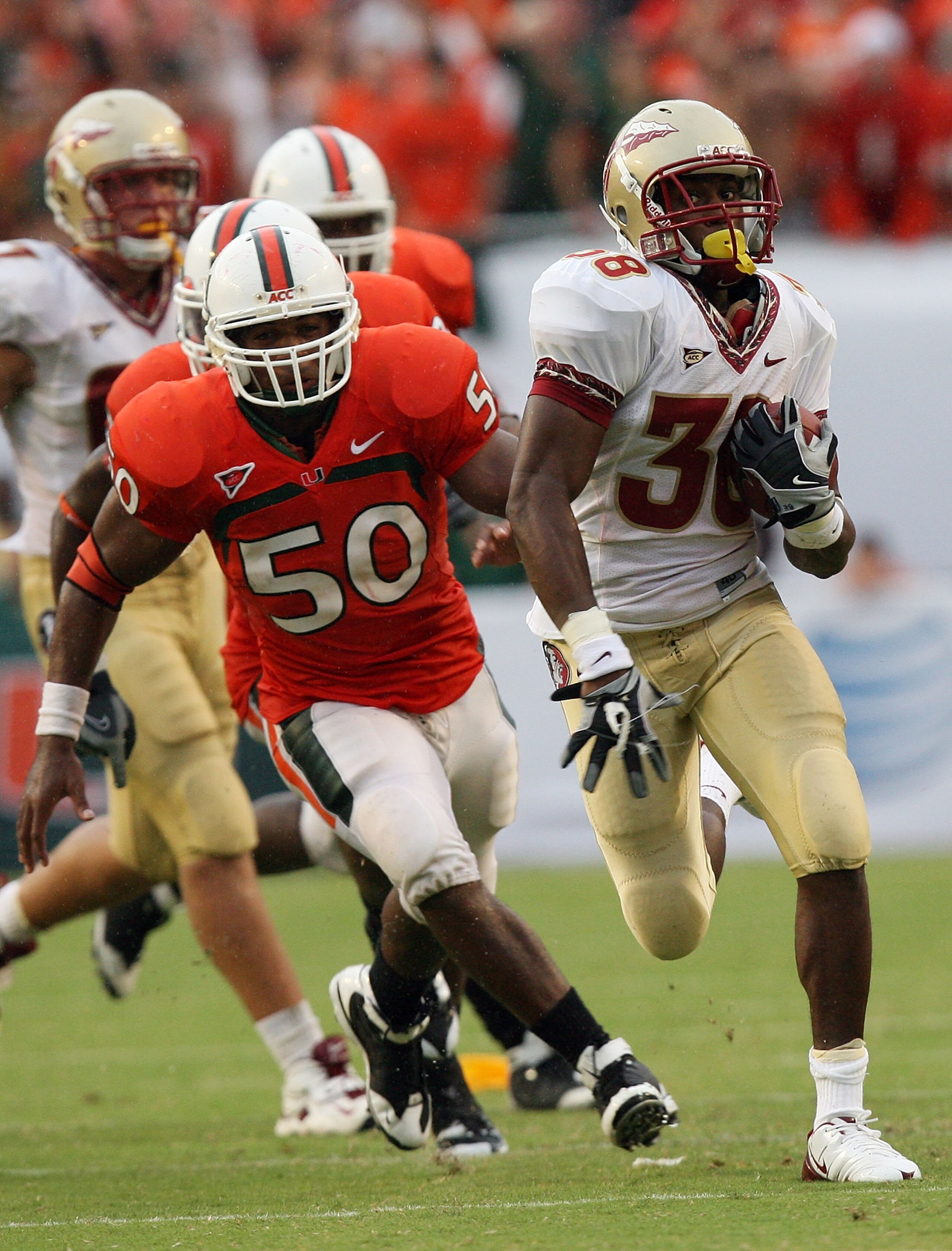 MIAMI - OCTOBER 04:  Running back Jermaine Thomas #38 of the Florida State Seminoles breaks away from linebacker Darryl Sharpton #50 of the Miami Hurricanes at Dolphin Stadium on October 4, 2008 in Miami, Florida. Florida State defeated Miami 41-39.  (Pho