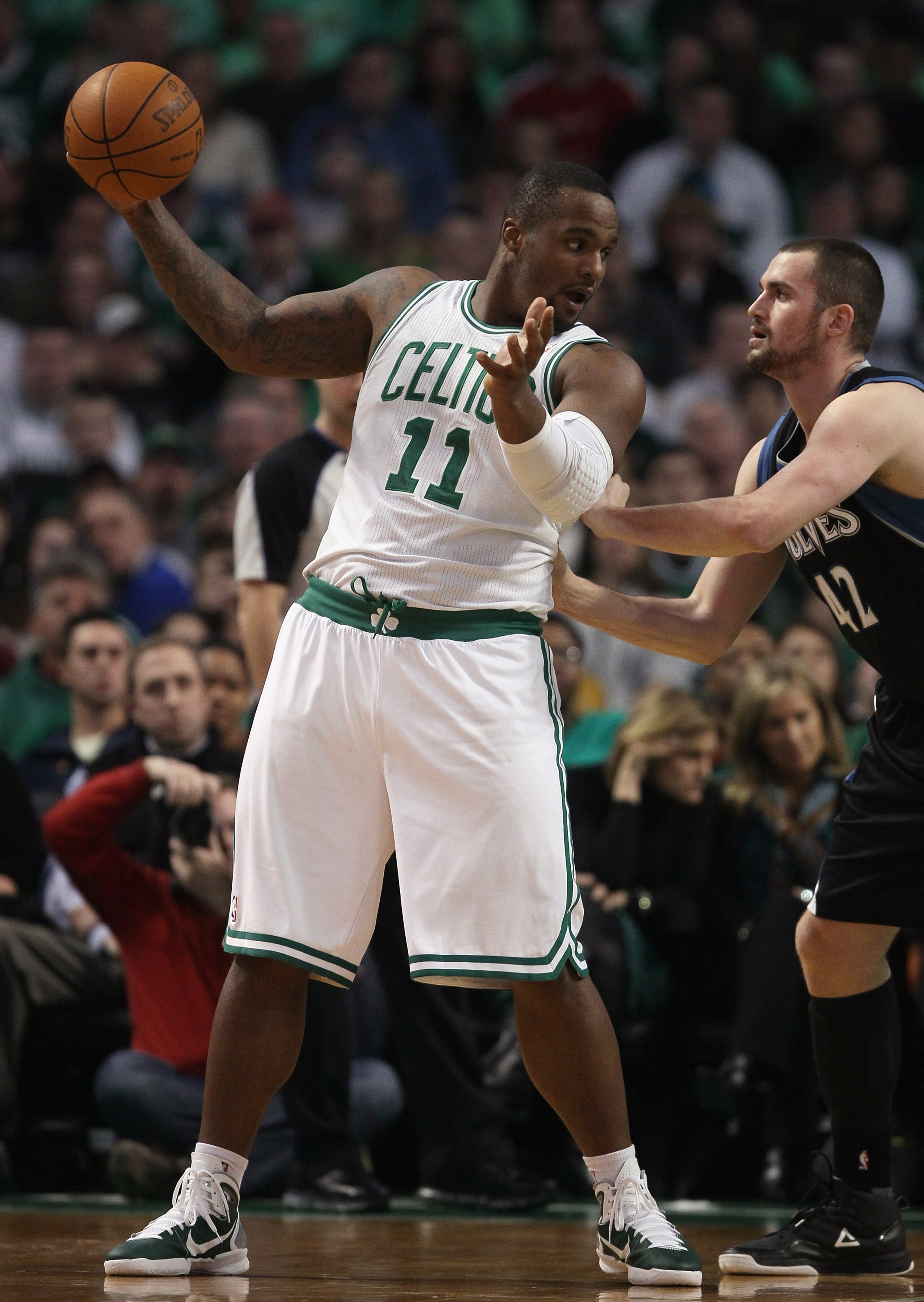BOSTON, MA - JANUARY 03:  Glen Davis #11 of the Boston Celtics heads for the basket as Kevin Love #42 of the Minnesota Timberwolves defends on January 3, 2011 at the TD Garden in Boston, Massachusetts. NOTE TO USER: User expressly acknowledges and agrees
