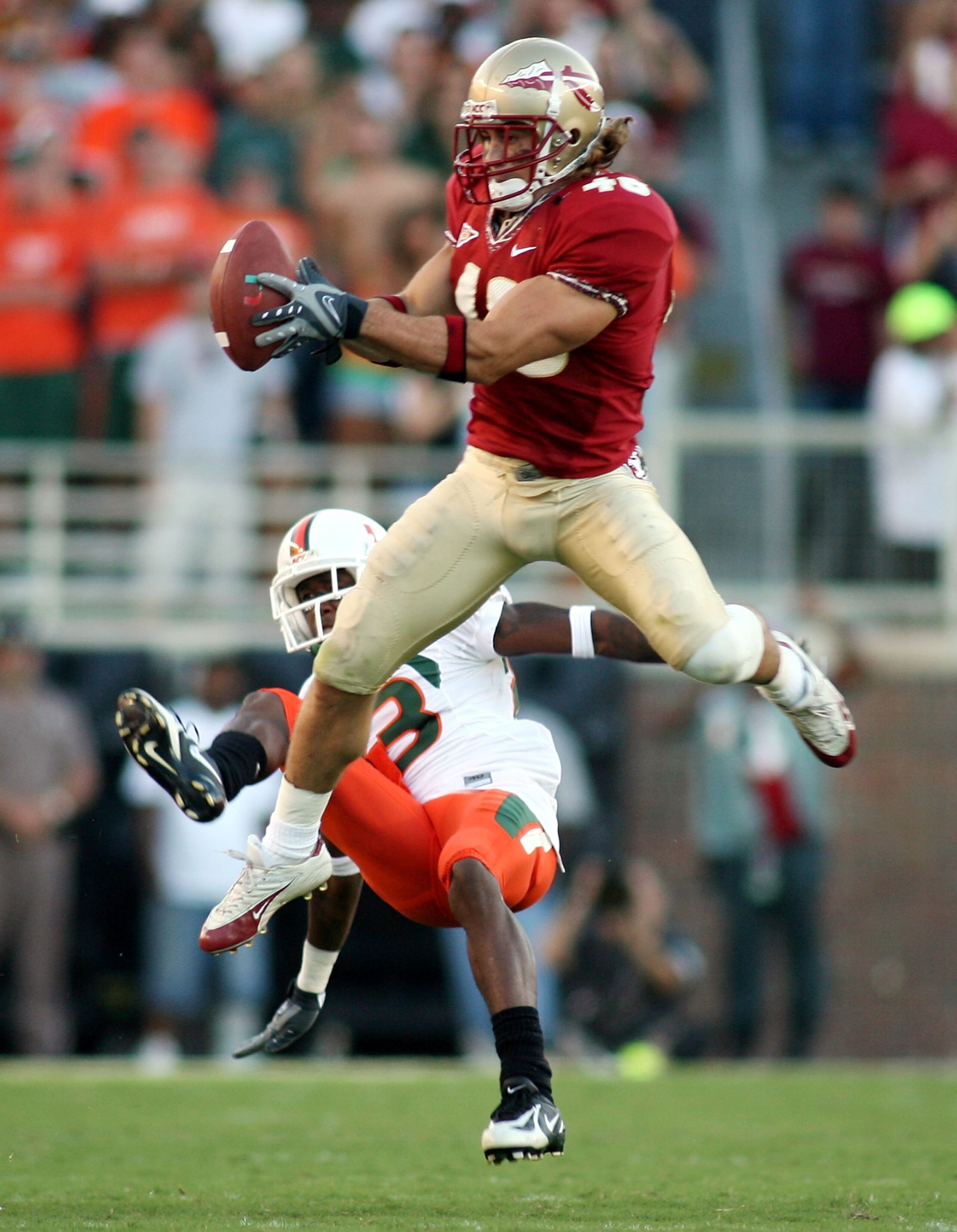 TALLAHASSEE, FL - OCTOBER 20:  Defensive back Anthony Houllis #46 of the Florida State Seminoles intercepts a pass in front of receiver Sam Shields #83 of the University of Miami Hurricanes in the second quarter at Bobby Bowden Field at Doak Campbell Stad