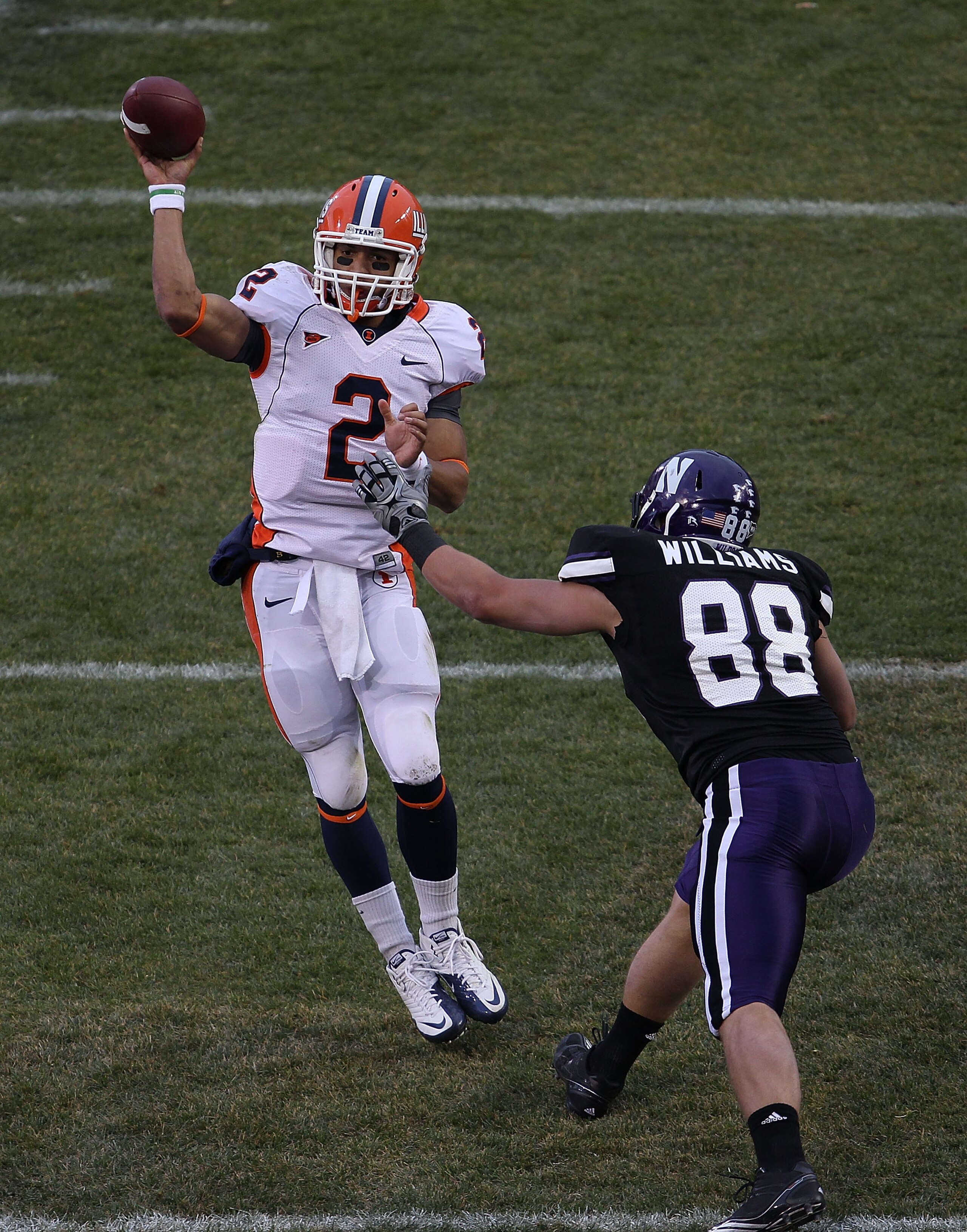 CHICAGO - NOVEMBER 20: Nathan Scheelhaase #2 of the Illinois Fighting Illini passes the ball under pressure from Quentin Williams #88 of the Northwestern Wildcats during a game played at Wrigley Field on November 20, 2010 in Chicago, Illinois. (Photo by J CHICAGO - NOVEMBER 20: Nathan Scheelhaase #2 of the Illinois Fighting Illini passes the ball under pressure from Quentin Williams #88 of the Northwestern Wildcats during a game played at Wrigley Field on November 20, 2010 in Chicago, Illinois. (Photo by J