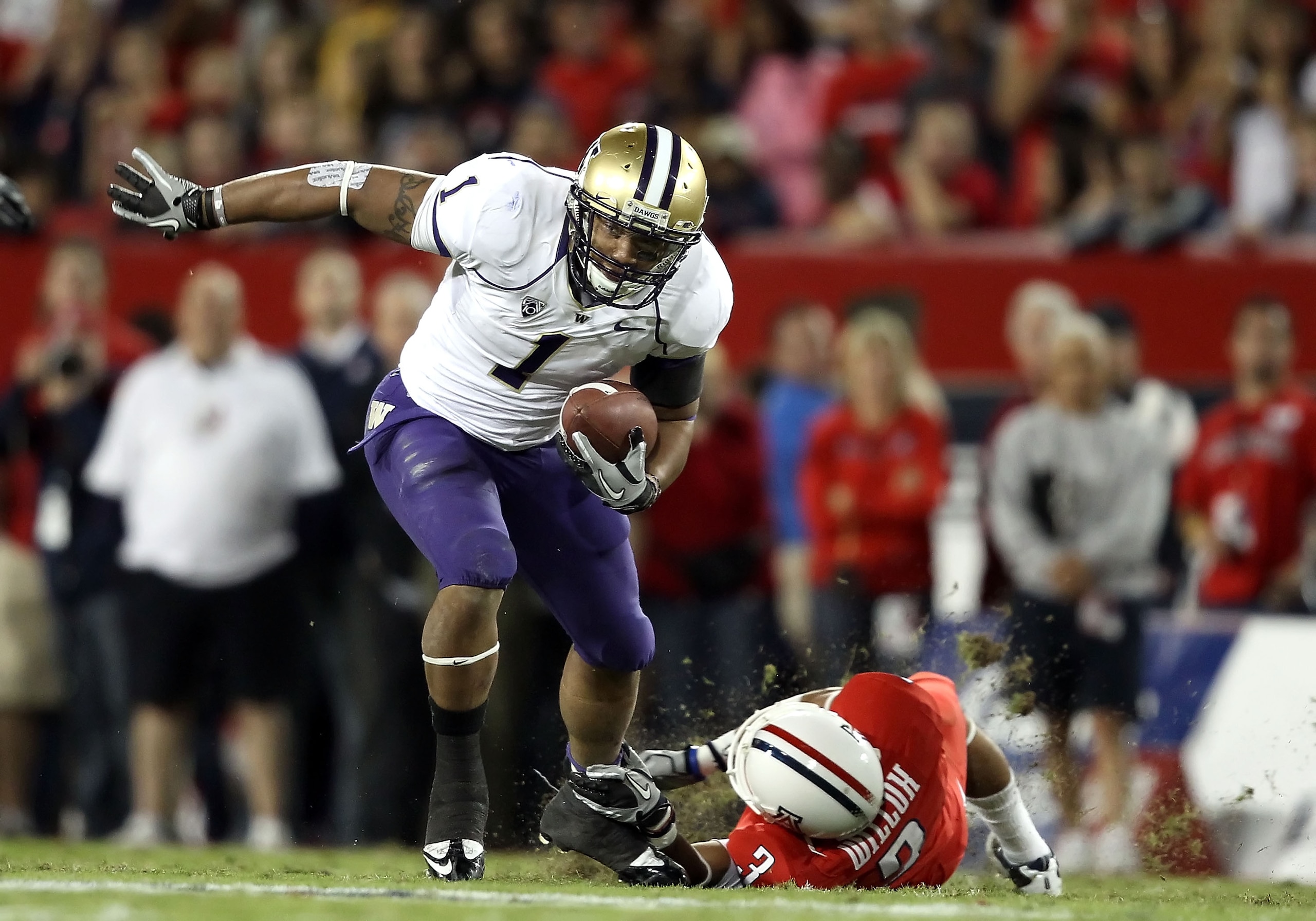 TUCSON, AZ - OCTOBER 23:  Runningback Chris Polk #1 of the Washington Huskies rushes the football during the college football game against the Arizona Wildcats at Arizona Stadium on October 23, 2010 in Tucson, Arizona. The Wildcats defeated the Huskies 44