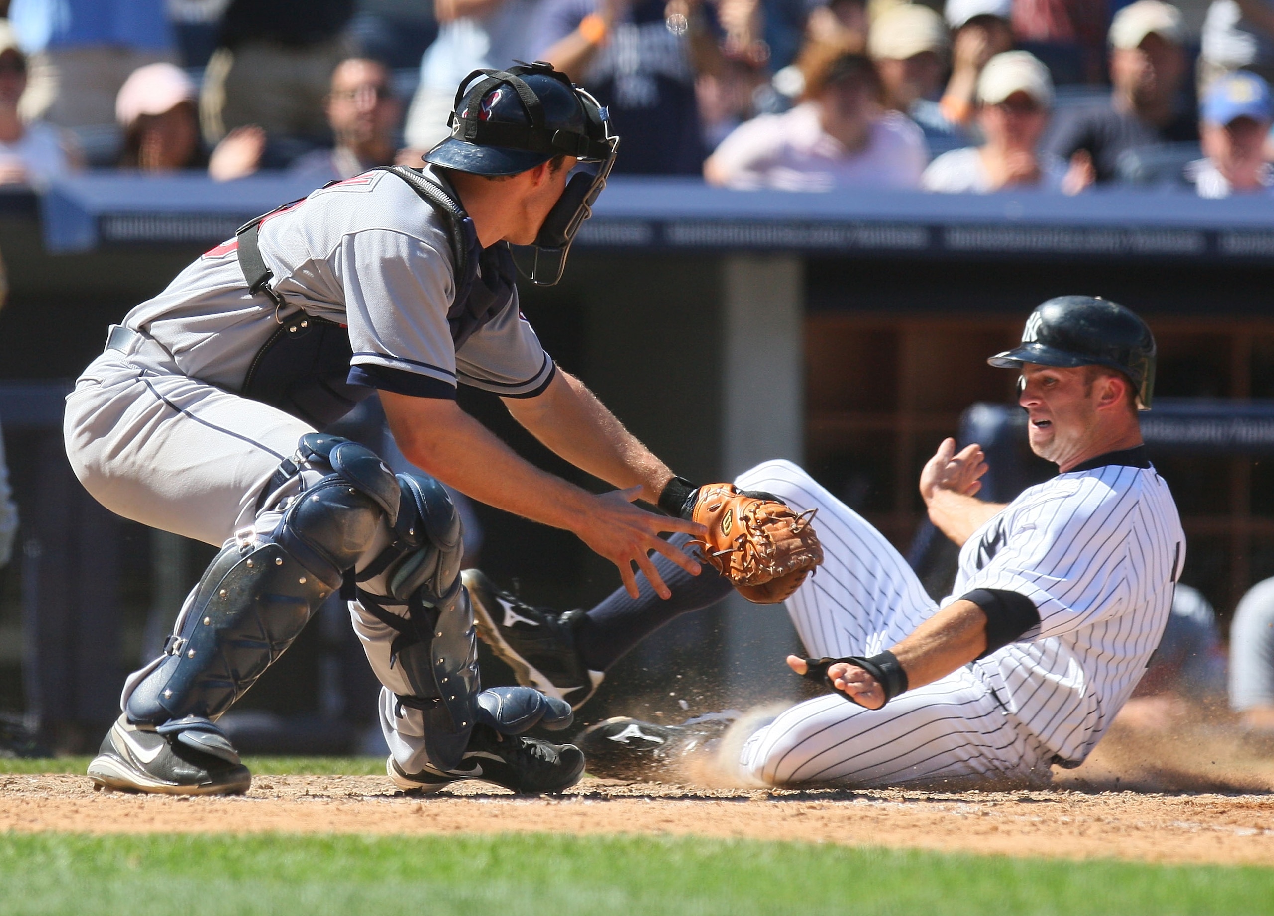 NEW YORK - MAY 30:  Brett Gardner #11 of the New York Yankees slides in ahead of the tag by Lou Marson #30 of the Cleveland Indians on Derek Jeter's (not shown RBI single in the seventh-inning) on May 30, 2010 in the Bronx borough of New York City.  (Phot