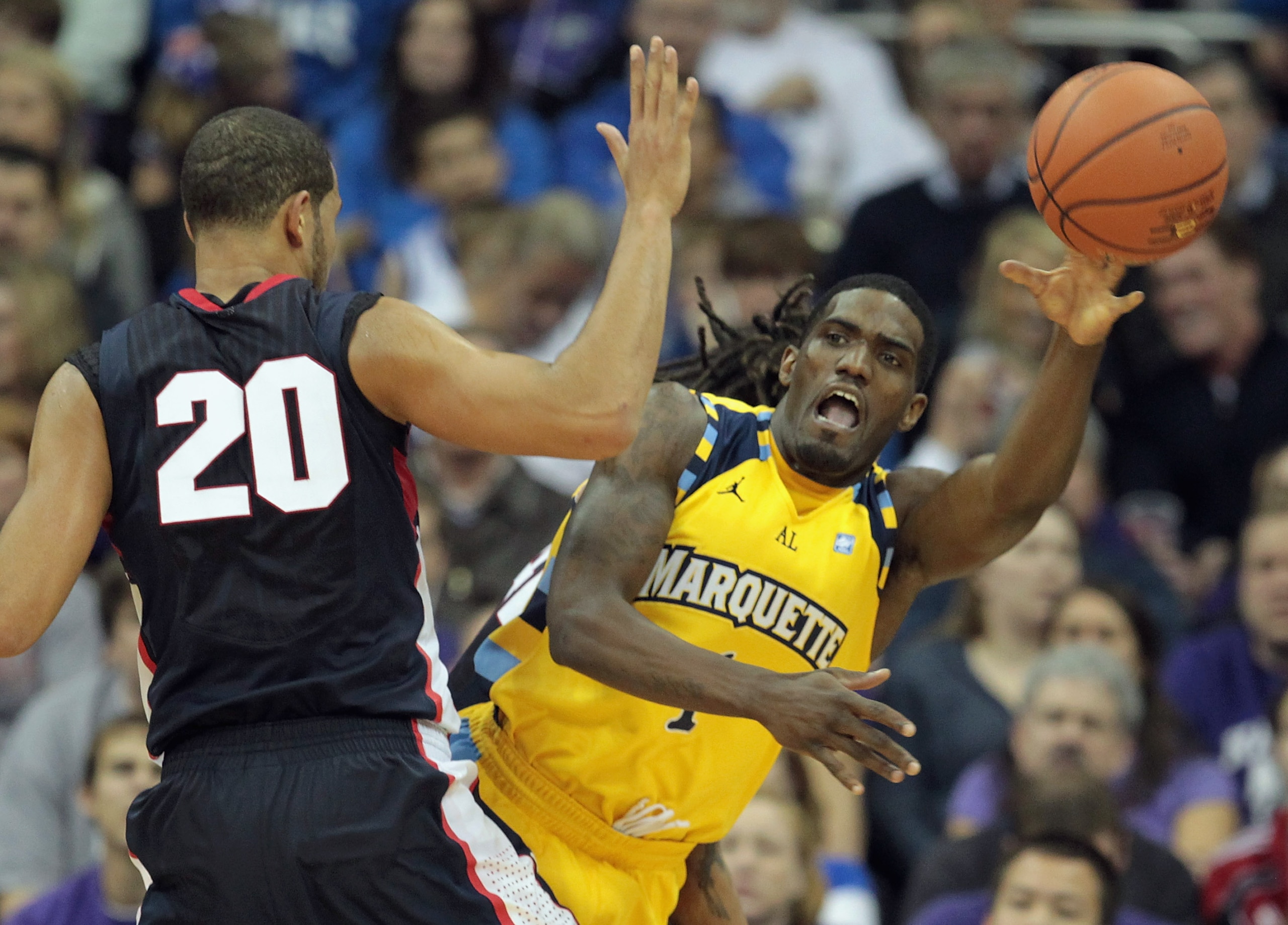 KANSAS CITY, MO - NOVEMBER 23:  Darius Johnson-Odom #1 of the Marquette Golden Eagles passes around Elias Harris #20 of the Gonzaga Bulldogs during the CBE Classic consolation game on November 23, 2010 at the Sprint Center in Kansas City, Missouri.  (Phot