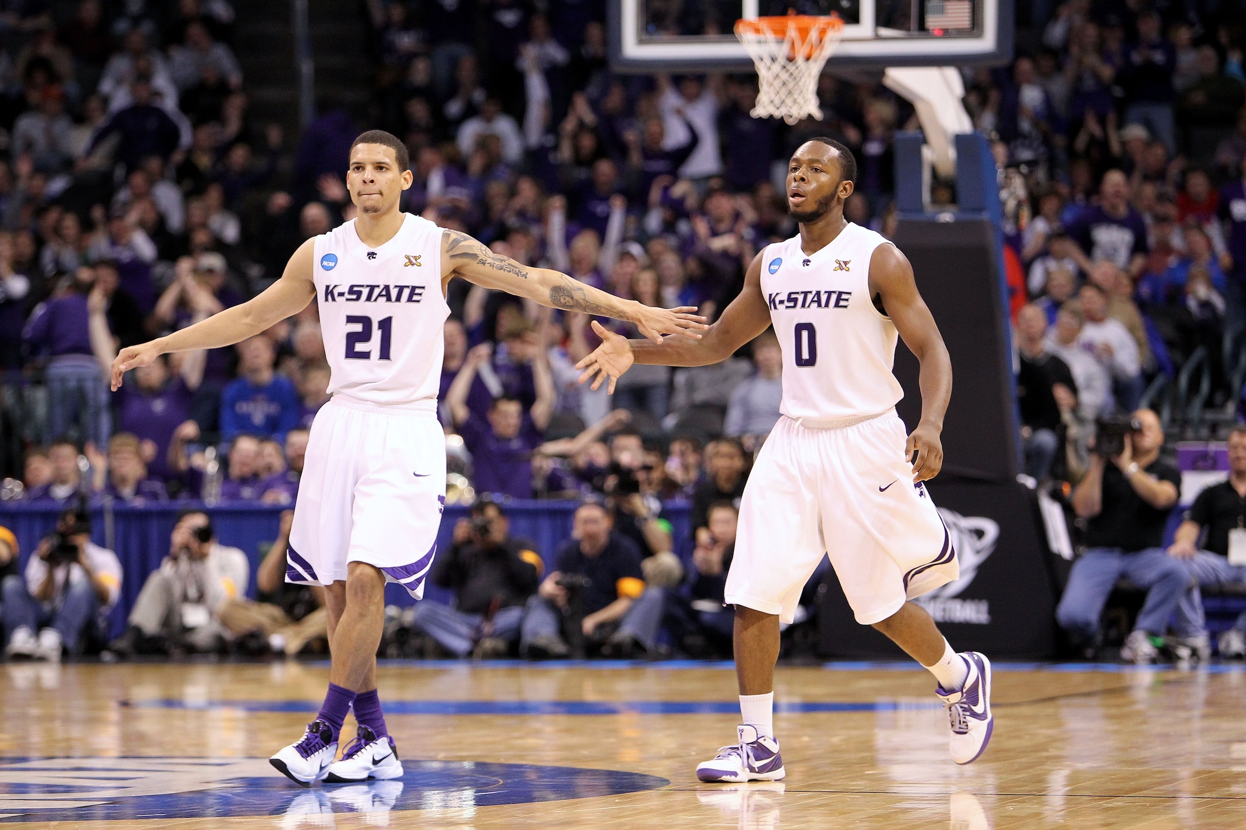 OKLAHOMA CITY - MARCH 20:  (L-R) Denis Clemente #21 and Jacob Pullen #0 of the Kansas State Wildcats celebrate a play against the Brigham Young Cougars during the second round of the 2010 NCAA men's basketball tournament at Ford Center on March 20, 2010 i