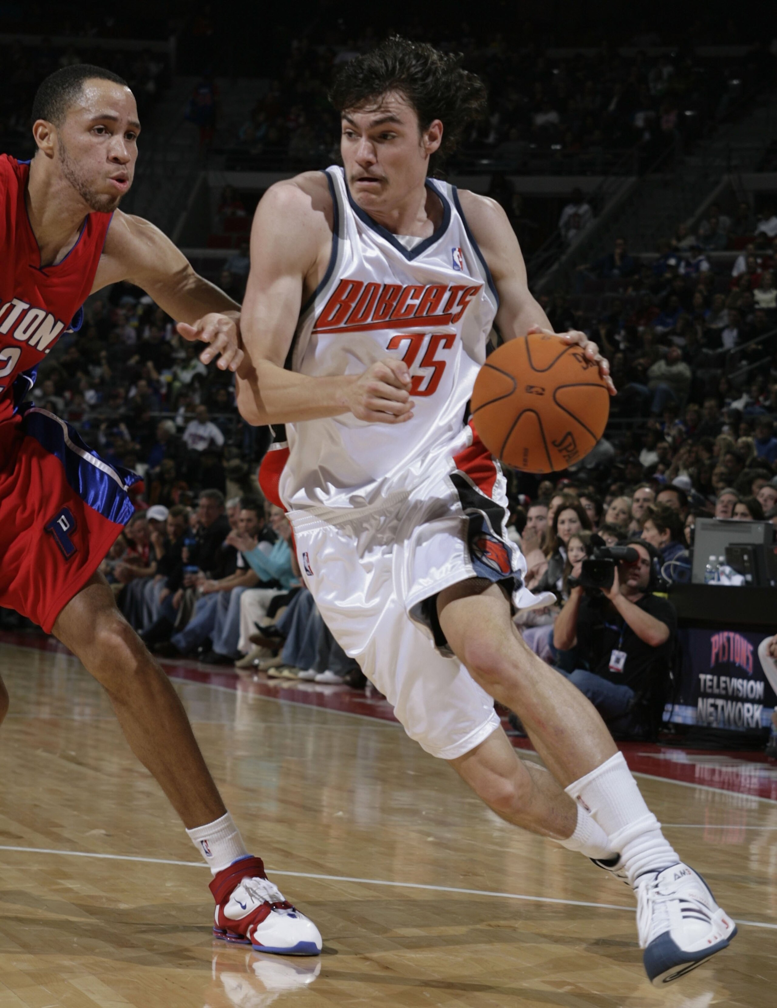 AUBURN HILLS, MI - NOVEMBER 24:  Adam Morrison #35 of the Charlotte Bobcats drives around Tayshaun Prince #22 of the Detroit Pistons on November 24, 2006 at the Palace of Auburn Hills in Auburn Hills, Michigan. NOTE TO USER: User expressly acknowledges an