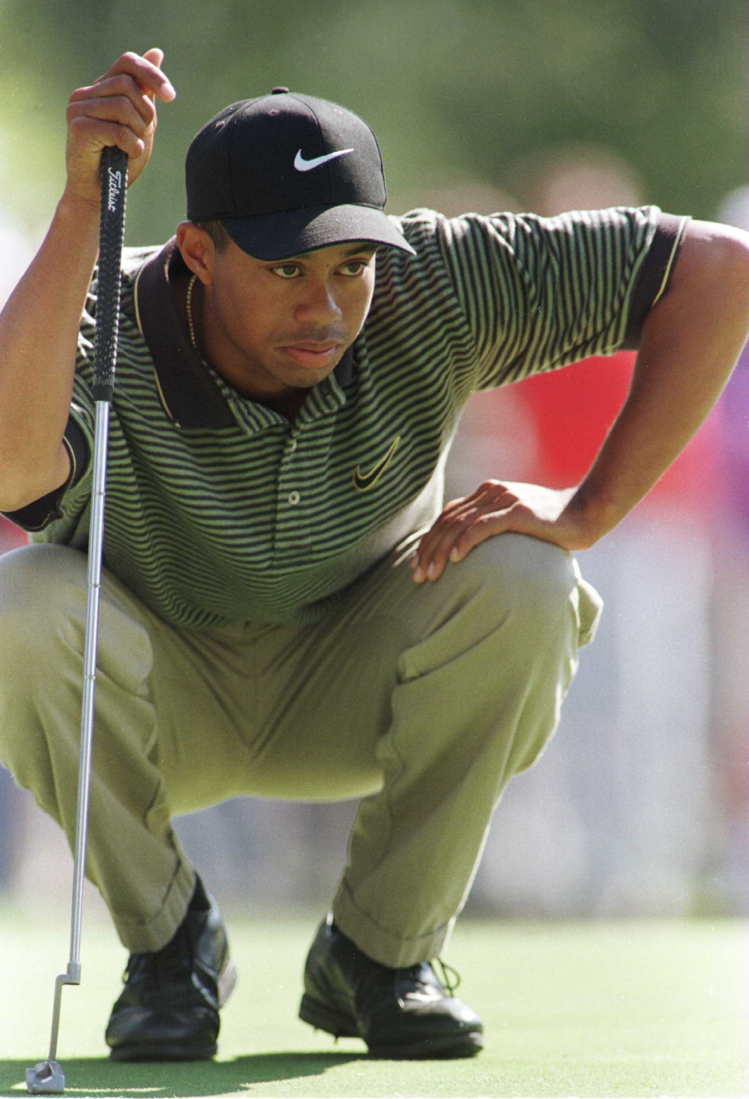 25 Oct 1996: Tiger Woods lines up a putt on the third hole during the second round of the 1996 PGA Tour Championship at Southern Hills Country Club in Tulsa, Oklahoma. Woods shot an 8 over par 78 and is at 8 over for the tournament.