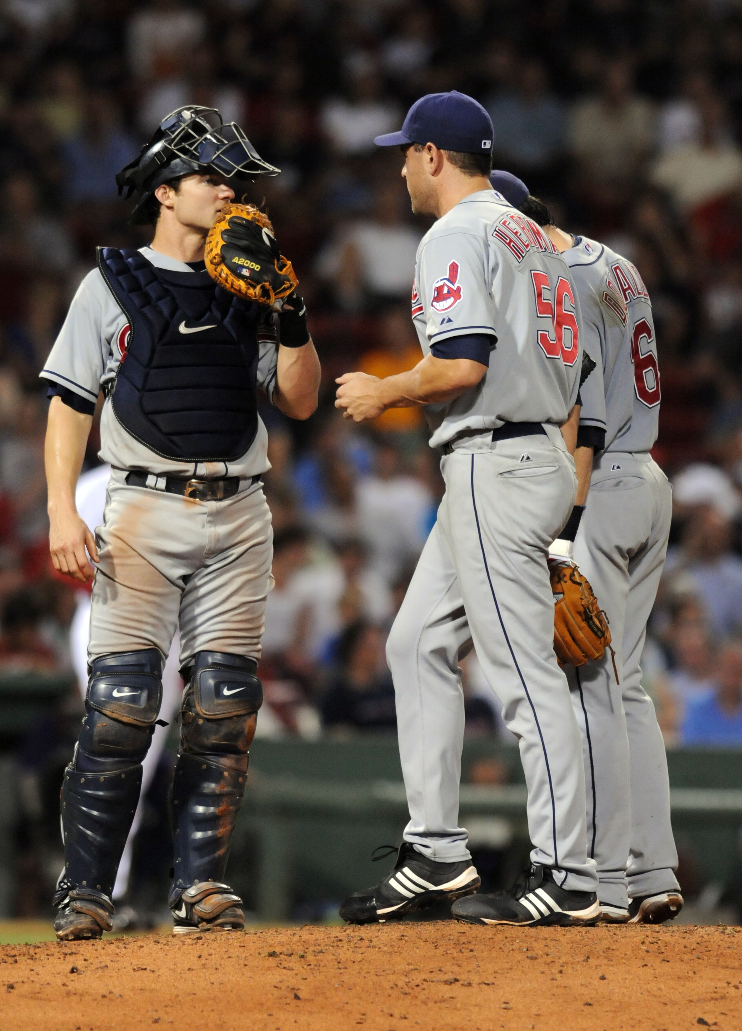 BOSTON, MA - AUGUST 5: Lou Marson #30 of the Cleveland Indians talks with pitcher Frank Herrmann #56 and shortstop Jason Donald #16 during the eight inning against the Boston Red Sox August 5, 2010 at Fenway Park in Boston, Massachusetts. (Photo by Darren