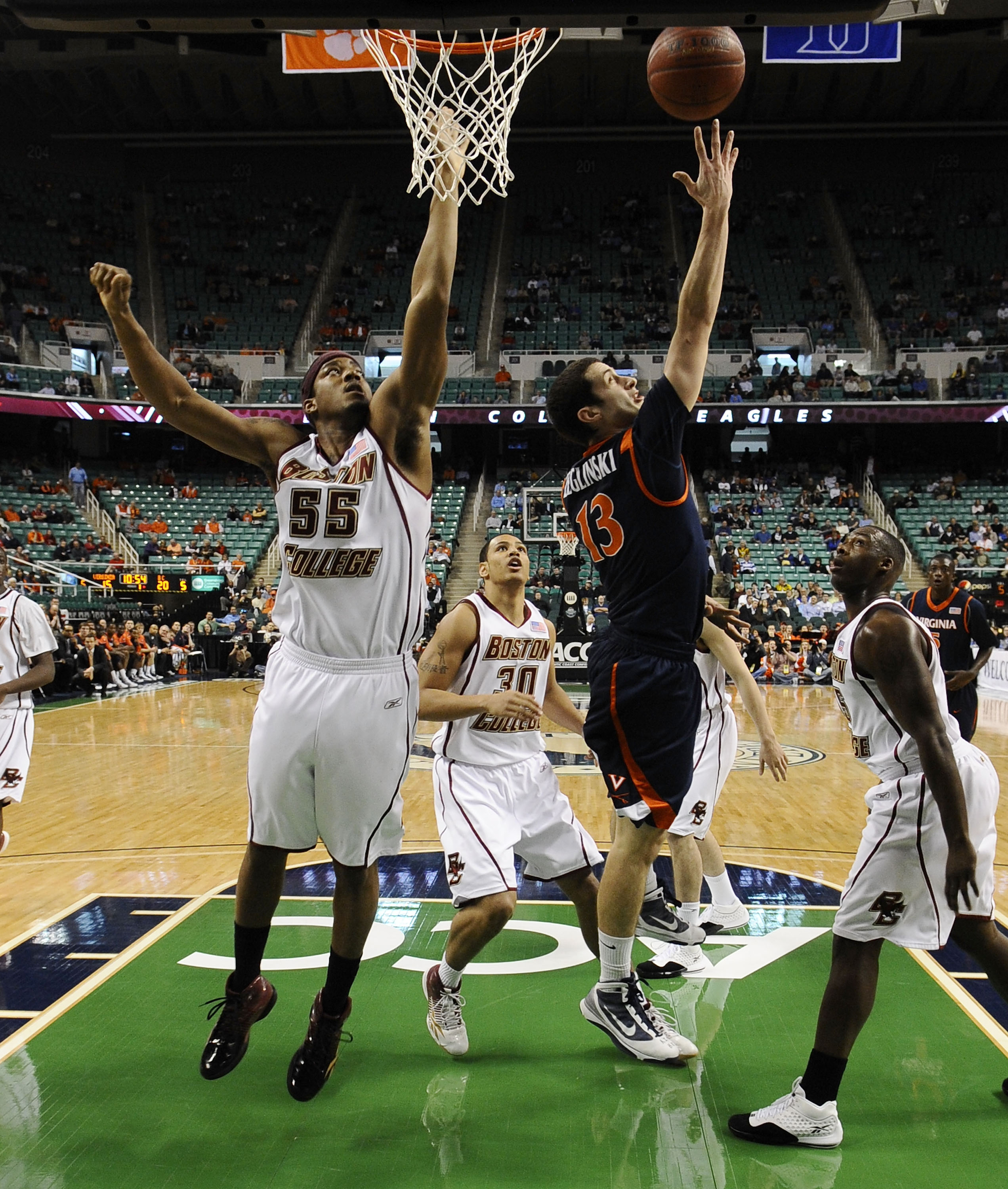 GREENSBORO, NC - MARCH 11:  Sammy Zeglinski #13 of the University of Virginia Cavaliers drives to the hoop past  Josh Southern #55 of the Boston College Eagles in their first round game in the 2010 ACC Men's Basketball Tournament at the Greensboro Coliseu