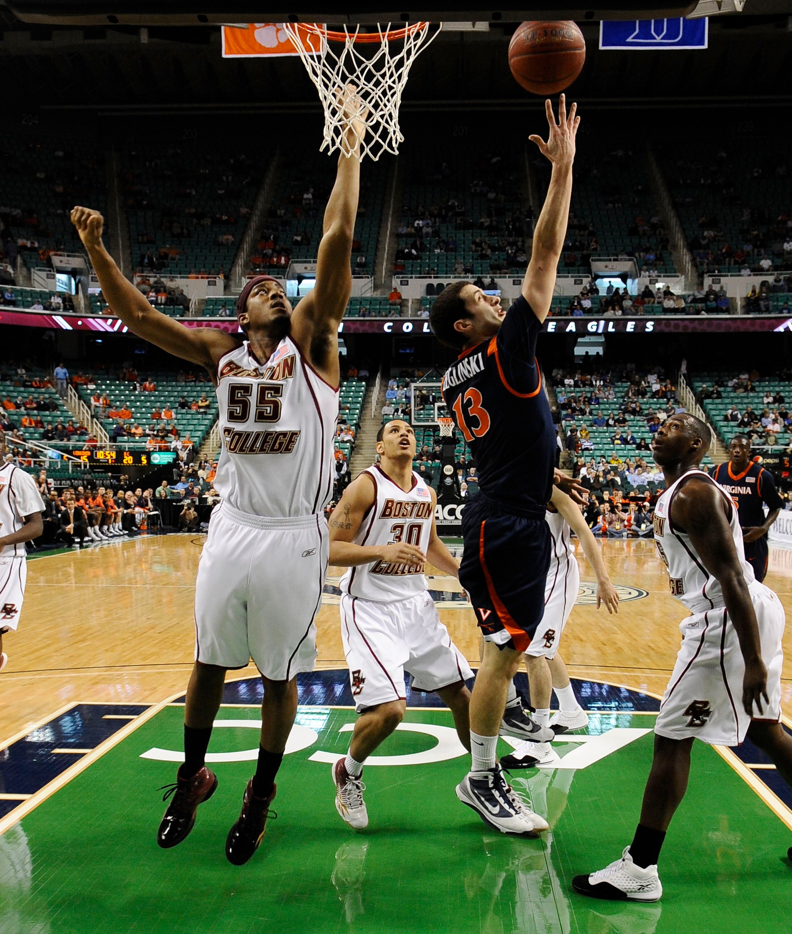 GREENSBORO, NC - MARCH 11:  Sammy Zeglinski #13 of the University of Virginia Cavaliers drives to the hoop past  Josh Southern #55 of the Boston College Eagles in their first round game in the 2010 ACC Men's Basketball Tournament at the Greensboro Coliseu
