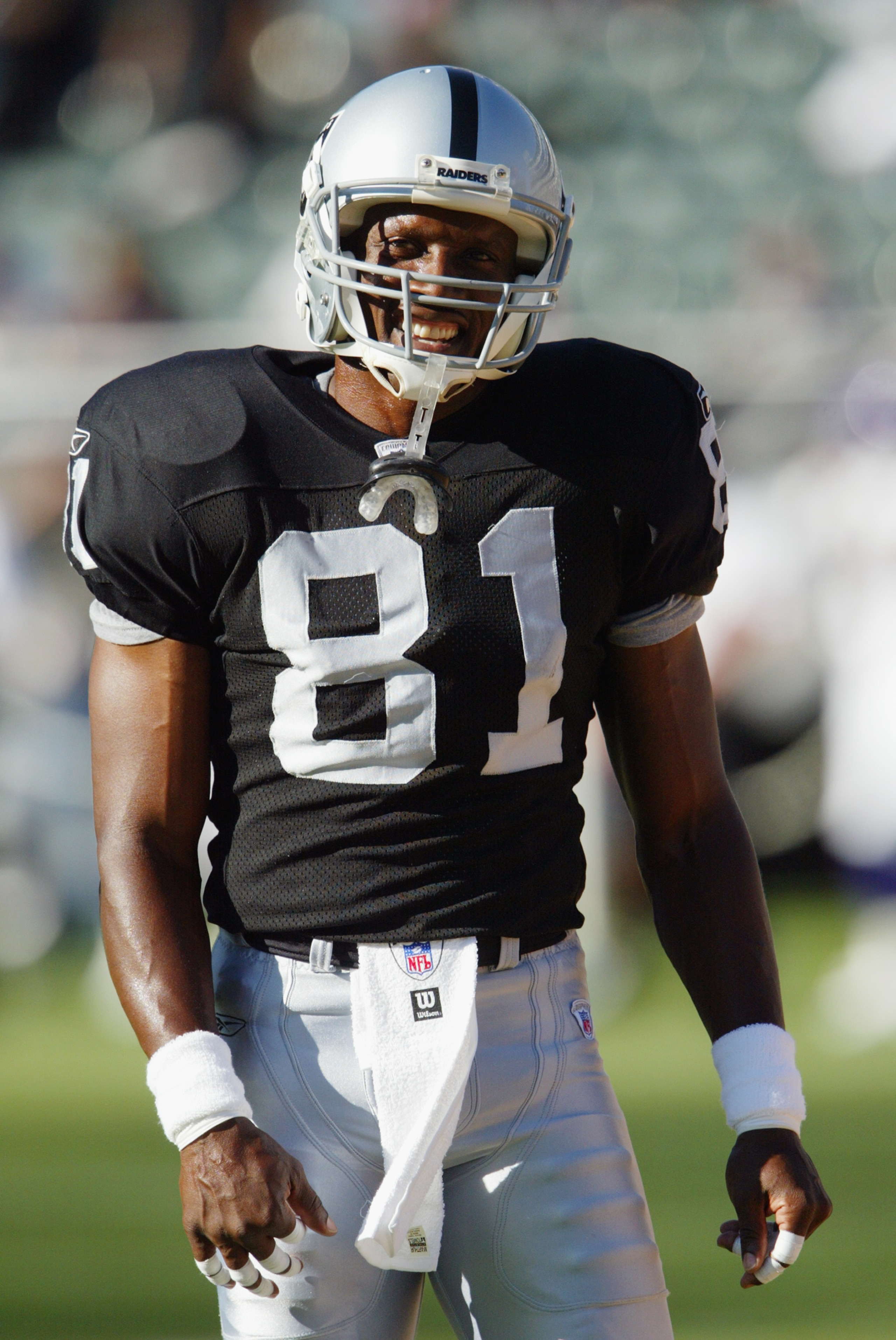 OAKLAND, CA - AUGUST 22 :  Tim Brown #81 of the Oakland Raiders smiles as he warms up before the game against the Minnesota Vikings on August 22, 2003 at the Network Associates Coliseum in Oakland, California.  The Vikings defeated the Raiders 21-6.  (Pho