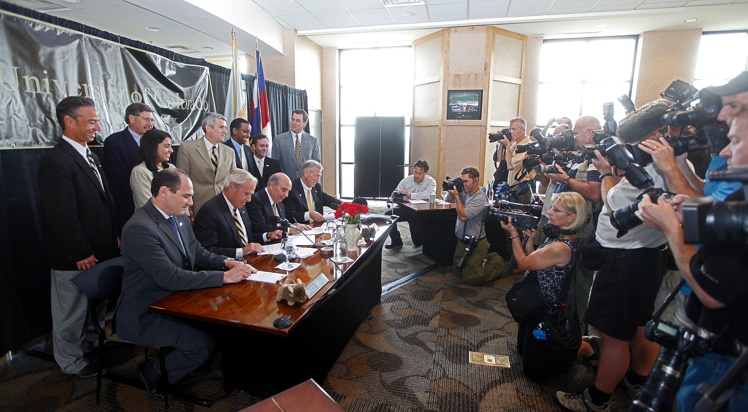 BOULDER, CO - JUNE 11: The University of Colorado Board of Regents sign the necessary paperwork after voting unanimously to accept an invitation to join the PAC-10 Conference during a public meeting at Folsom Stadium on June 11, 2010 in Boulder, Colorado.