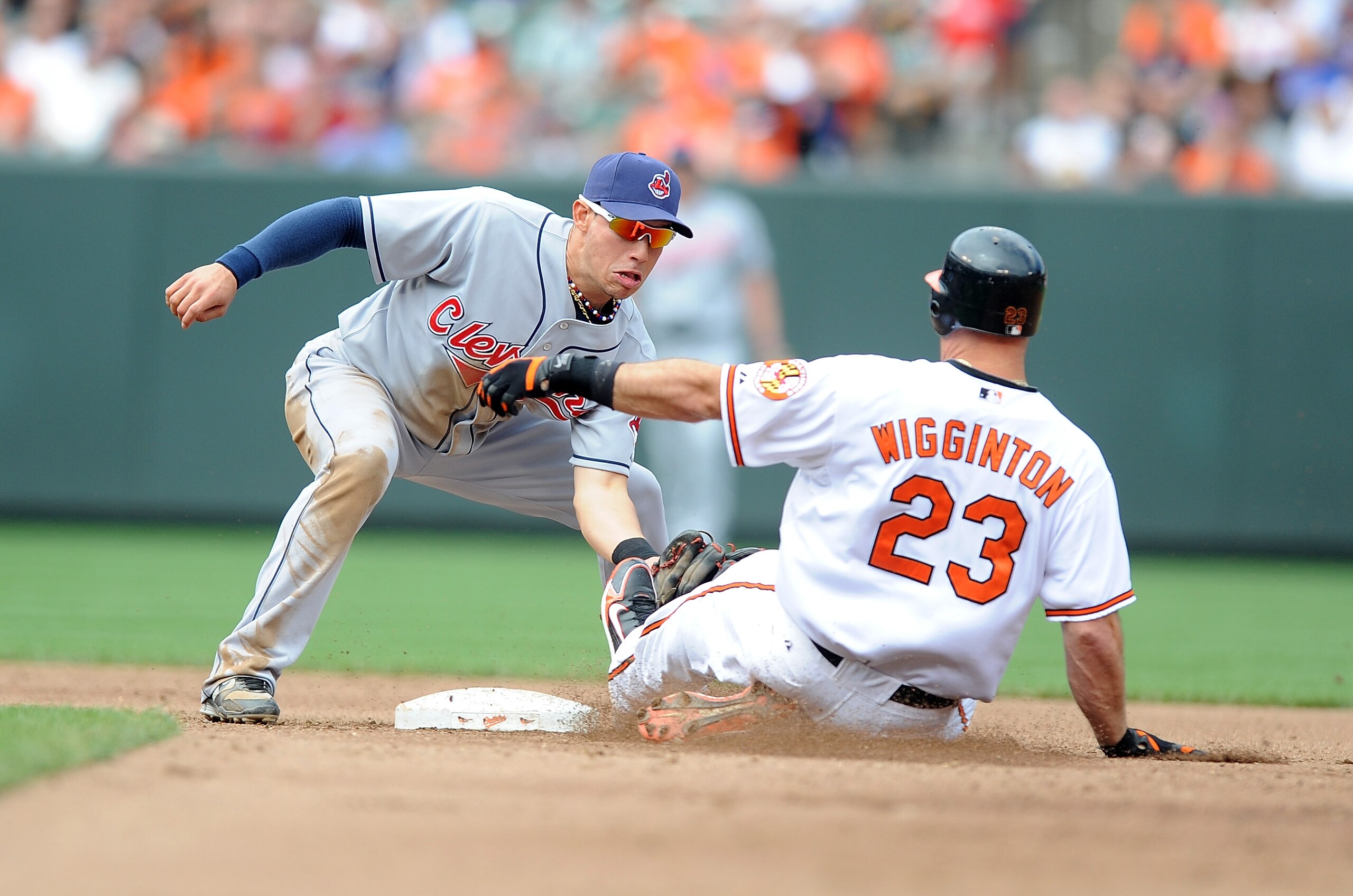 BALTIMORE - MAY 16:  Ty Wigginton #23 of the Baltimore Orioles is tagged out trying to stretch a single into a double by Asdrubal Cabrera #13 of the Cleveland Indians at Camden Yards on May 16, 2010 in Baltimore, Maryland.  (Photo by Greg Fiume/Getty Imag