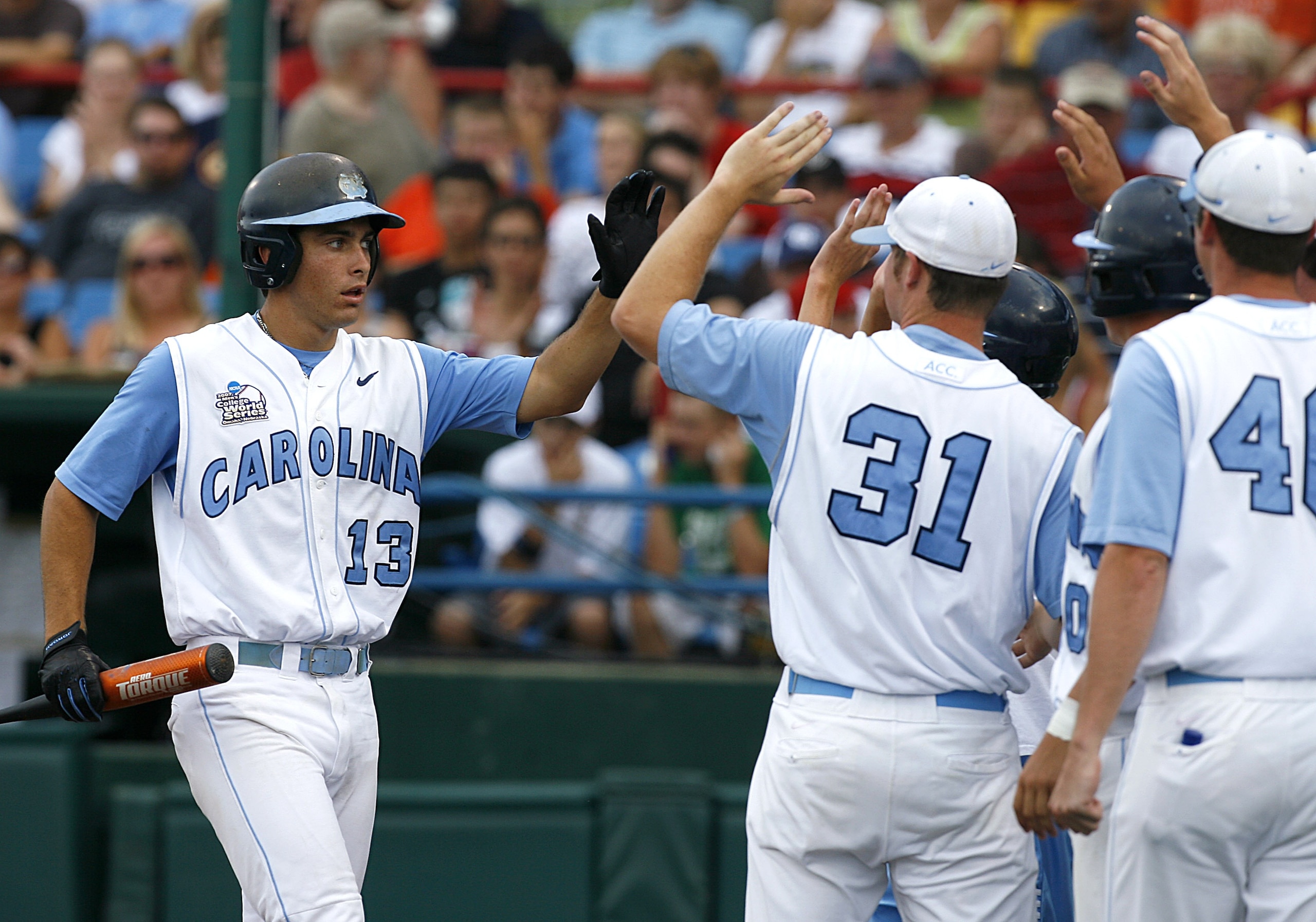 OMAHA, NE - JUNE 21:  First baseman Dustin Ackley #13 of the North Carolina Tar Heels celebrates with teammates after hitting a solo homer in the second inning to the give the Tar Heels a 1-0 lead over the Rice Owls in Game 13 of the NCAA College World Se
