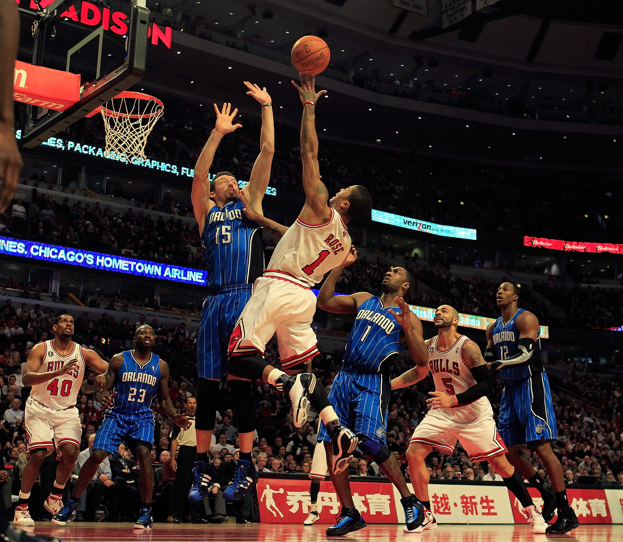 CHICAGO, IL - JANUARY 28: Derrick Rose #1 of the Chicago Bulls puts up a shot between Hedo Turkoglu #15 and Gilbert Arenas #1 of the Orlando Magic at the United Center on January 28, 2011 in Chicago, Illinois. The Bulls defeated the Magic 99-90. NOTE TO U