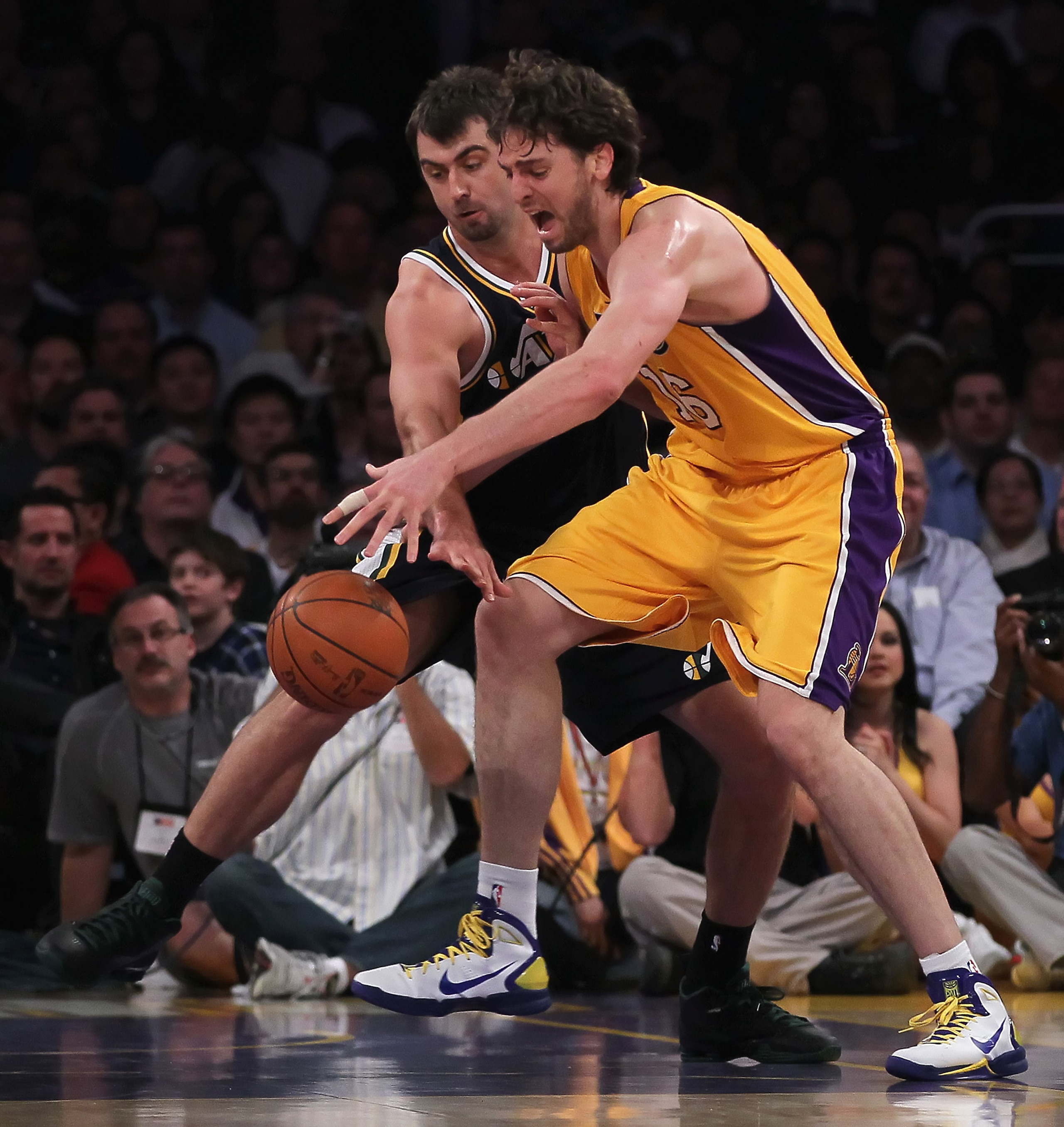LOS ANGELES, CA - JANUARY 25:  Mehmet Okur #13 of the Utah Jazz attempts to steal the ball from Pau Gasol #16 of the Los Angeles Lakers in the first half at Staples Center on January 25, 2011 in Los Angeles, California. The Lakers defeated the Jazz 120-91