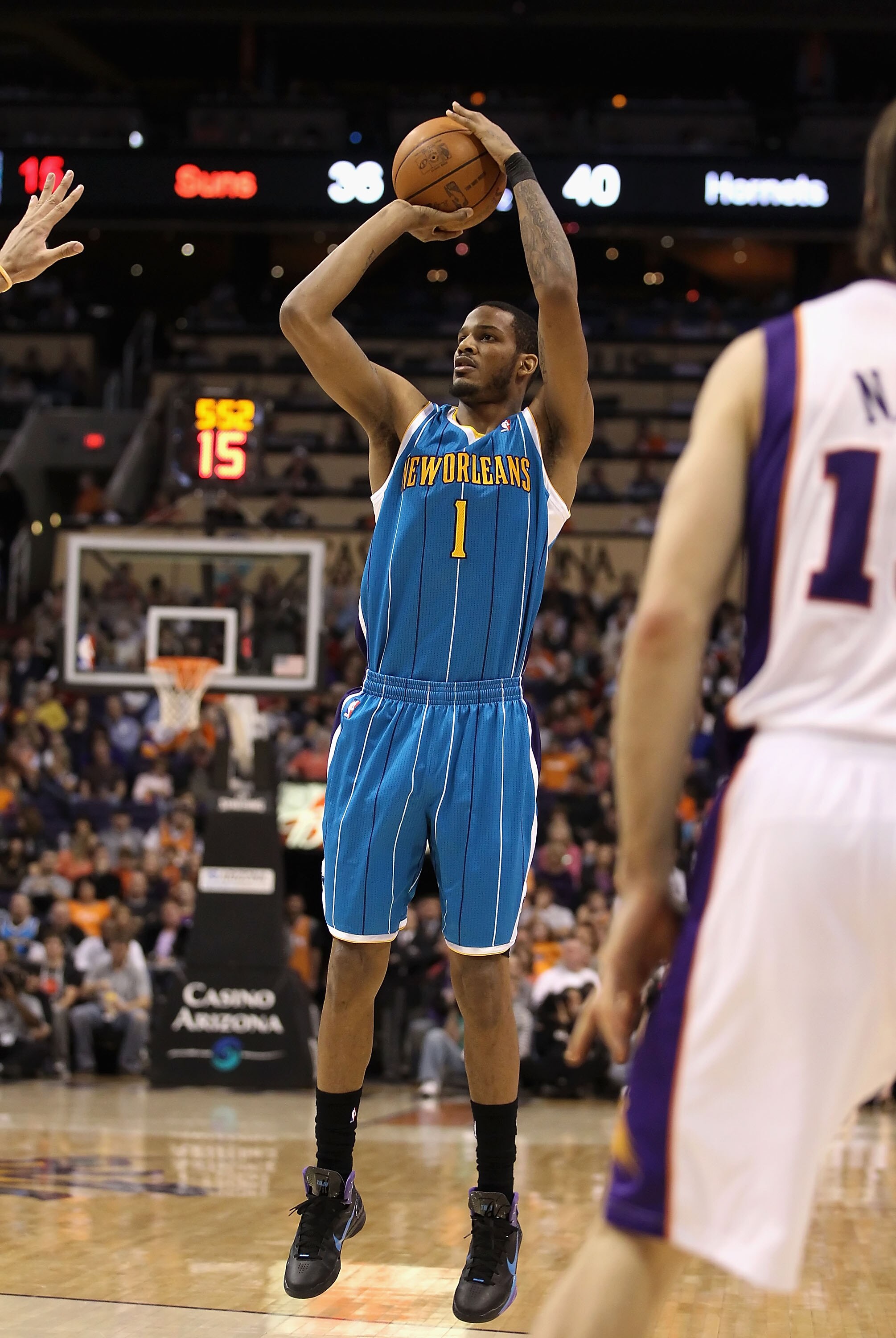 PHOENIX, AZ - JANUARY 30:  Trevor Ariza #1 of the New Orleans Hornets puts up a shot during the NBA game against  the Phoenix Suns at US Airways Center on January 30, 2011 in Phoenix, Arizona.  The Suns defeated the Hornets 104-102. NOTE TO USER: User exp