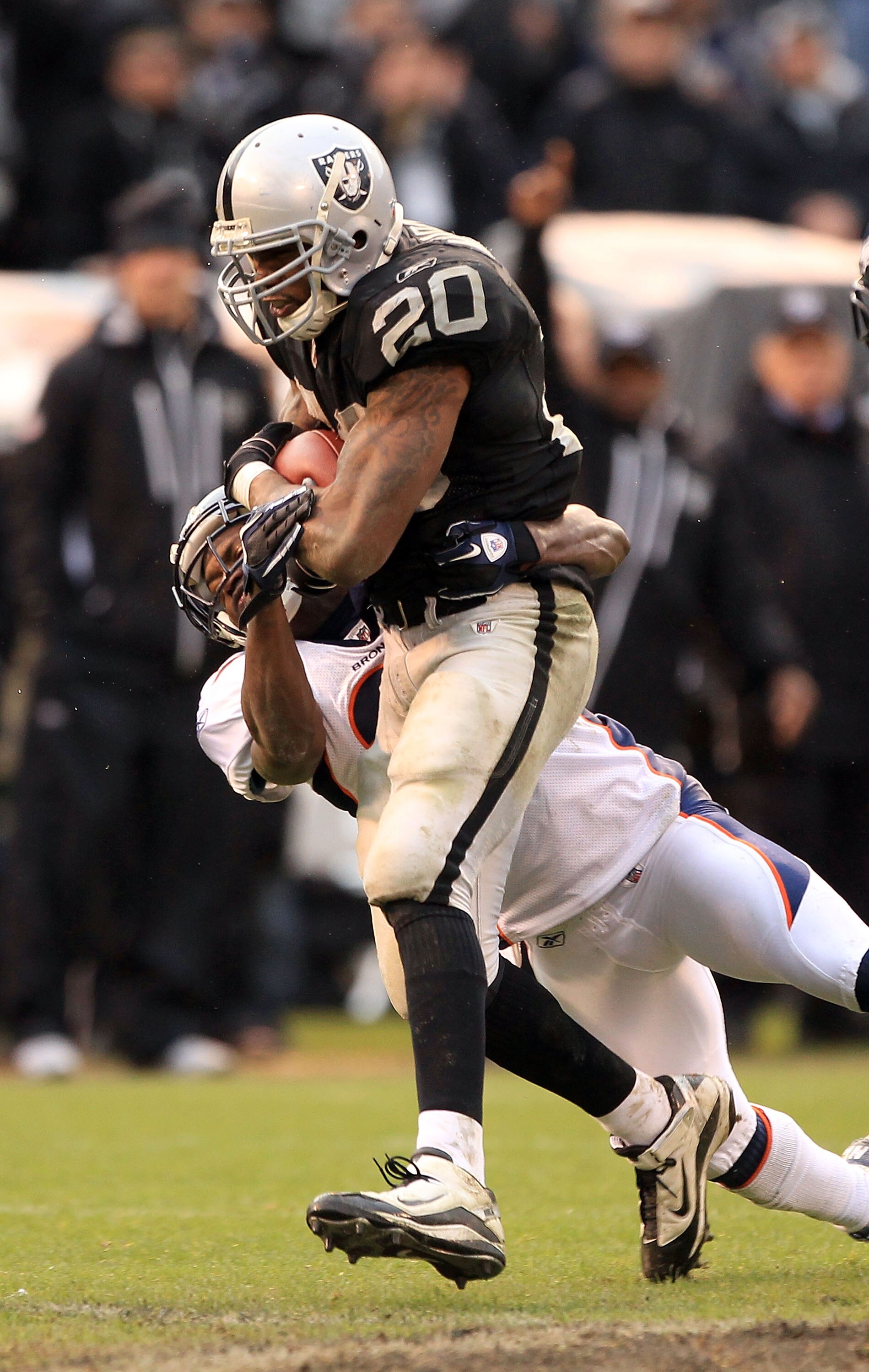 OAKLAND, CA - DECEMBER 19:  Darren McFadden #20 of the Oakland Raiders runs with the ball during their game against the Denver Broncos at Oakland-Alameda County Coliseum on December 19, 2010 in Oakland, California.  (Photo by Ezra Shaw/Getty Images)