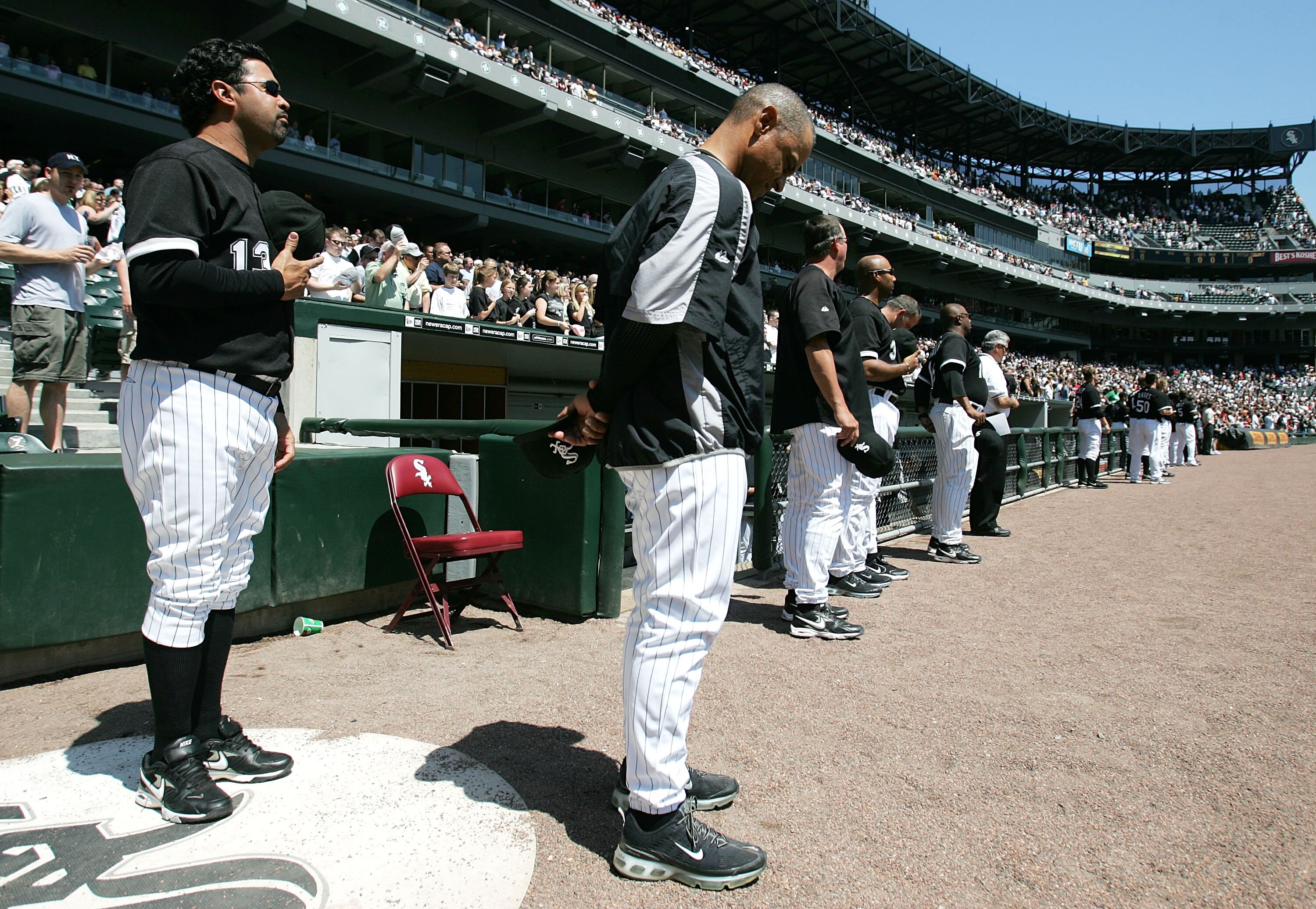 CHICAGO - APRIL 29:  Members of the Chicago White Sox including manager Ozzie Guillen #13 (L) and bench coach Joey Cora participate in a moment of silence for St. Louis Cardinals pitcher Josh Hancock before a game against the Los Angeles Angels of Anaheim