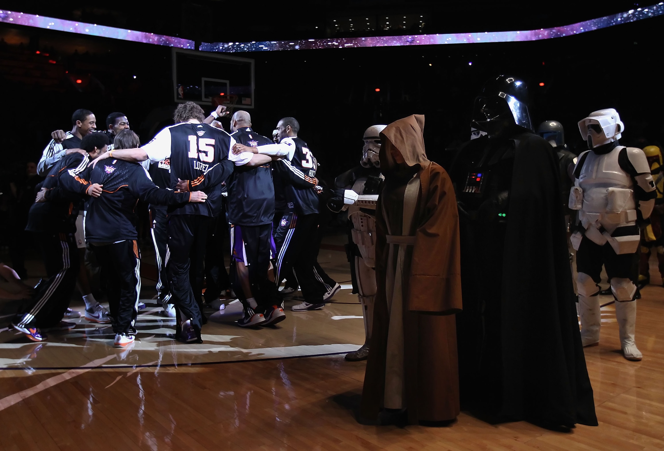 PHOENIX, AZ - FEBRUARY 13:  The Phoenix Suns huddle up on the court near Darth Vader and characters from 'Star Wars' before the NBA game against the Sacramento Kings at US Airways Center on February 13, 2011 in Phoenix, Arizona.  NOTE TO USER: User expres