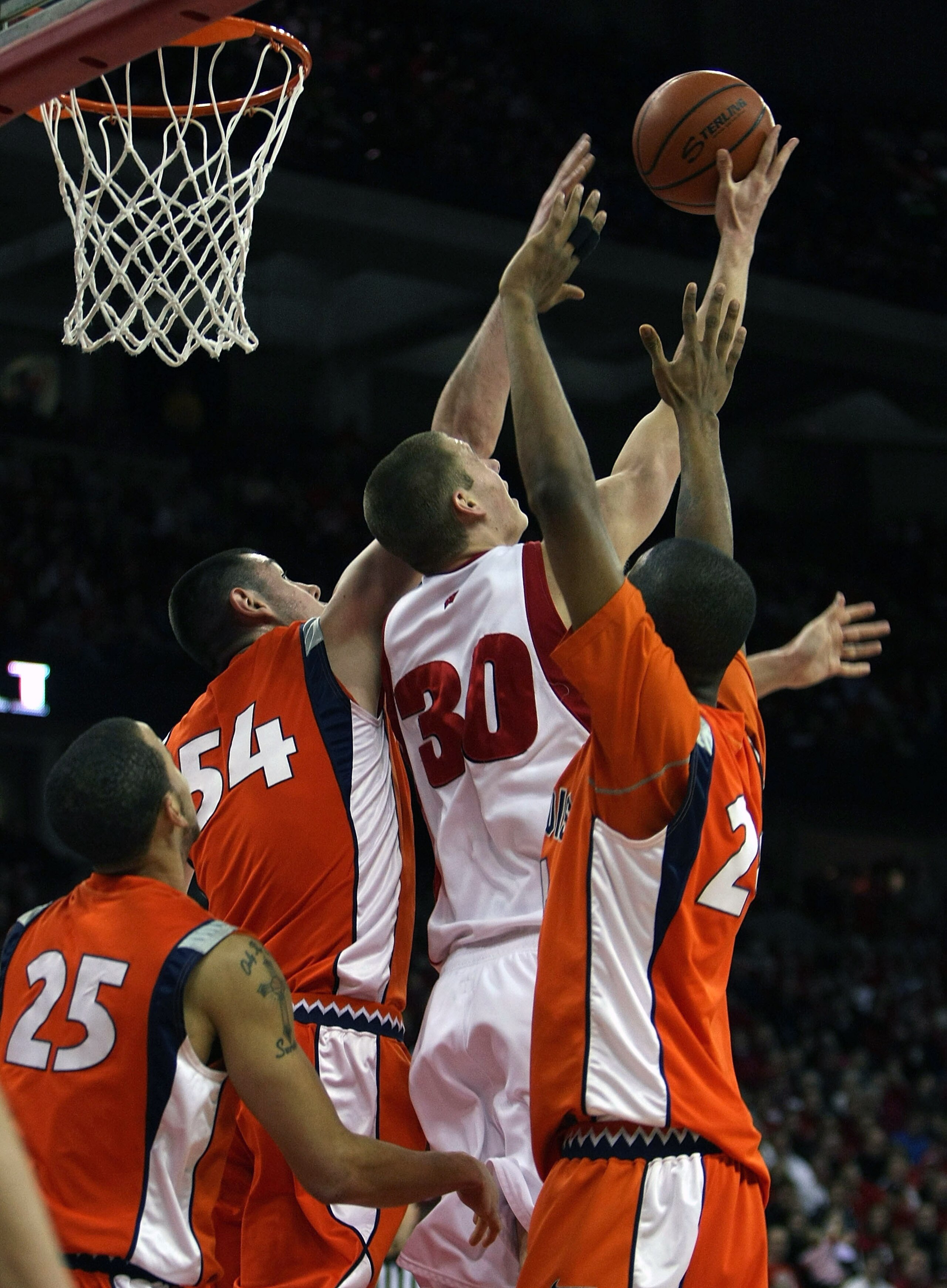 MADISON, WI - FEBRUARY 5: Jon Leuer #30 of the Wisconsin Badgers hits a shot with his back to the basket against Calvin Brock #25, Mike Tisdale #54 and Mike Davis #24 of the Illinois Fighting Illini at the Kohl Center February 5, 2009 in Madison, Wisconsi