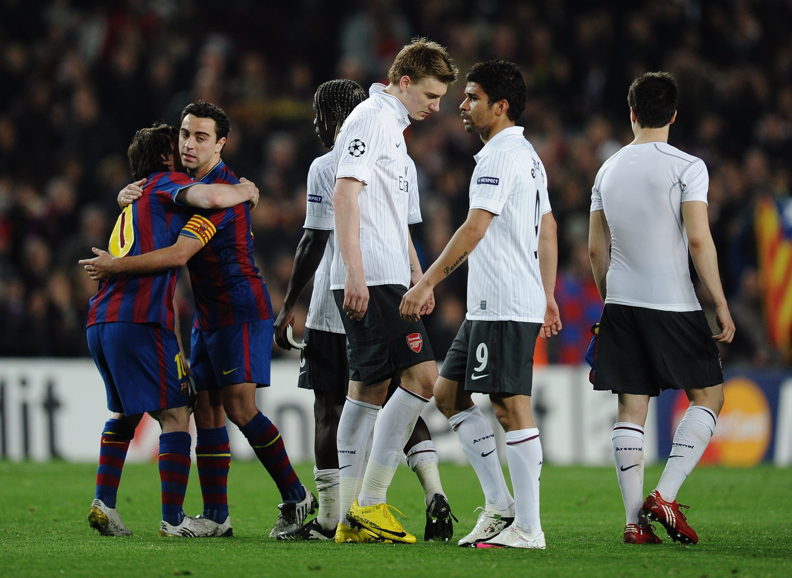 BARCELONA, SPAIN - APRIL 06:  Lionel Messi of Barcelona celebrates as Nicklas Bendtner and Eduardo of Arsenal look dejected after the UEFA Champions League quarter final second leg match between Barcelona and Arsenal at Camp Nou on April 6, 2010 in Barcel