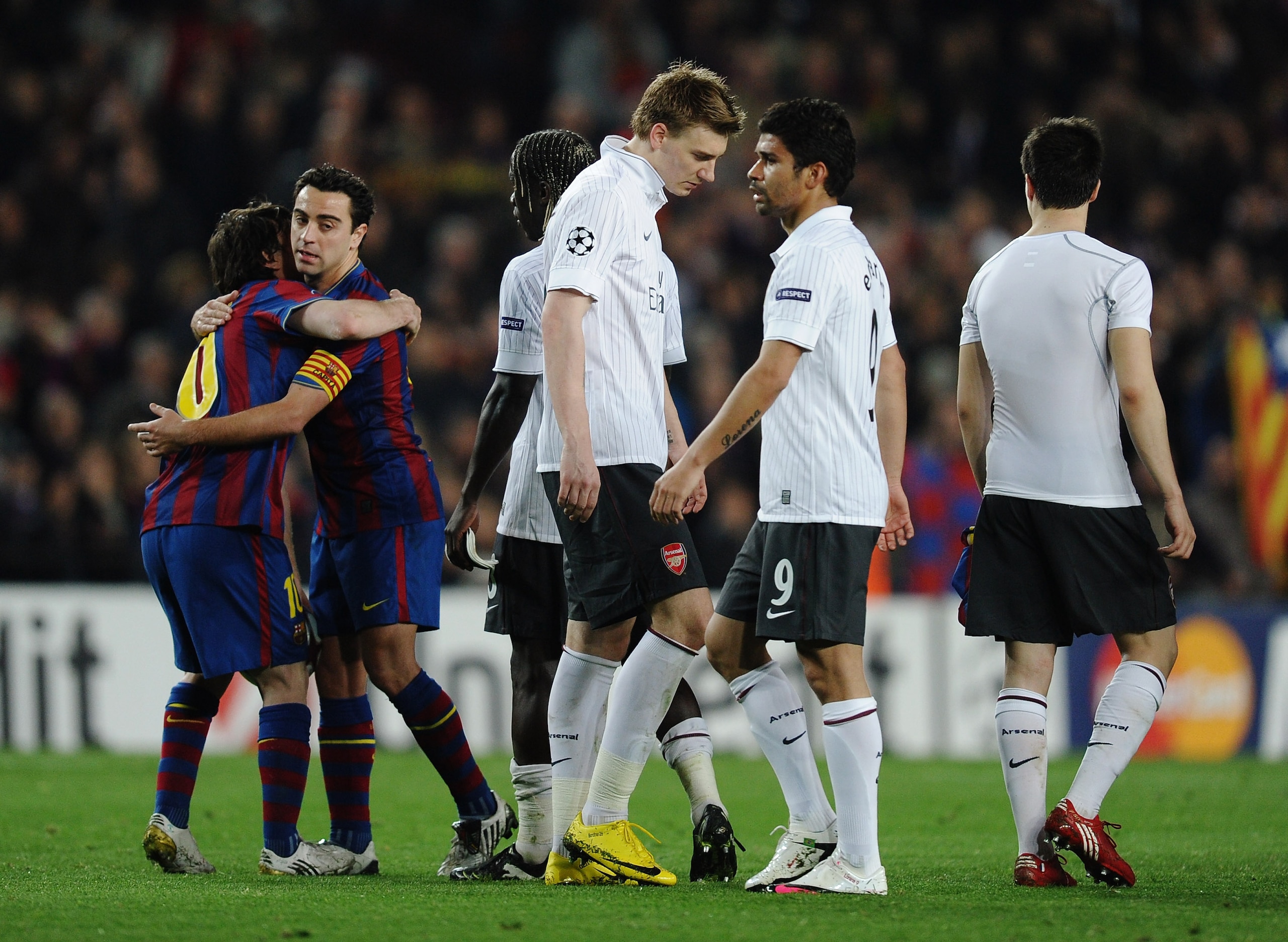 BARCELONA, SPAIN - APRIL 06:  Lionel Messi of Barcelona celebrates as Nicklas Bendtner and Eduardo of Arsenal look dejected after the UEFA Champions League quarter final second leg match between Barcelona and Arsenal at Camp Nou on April 6, 2010 in Barcel