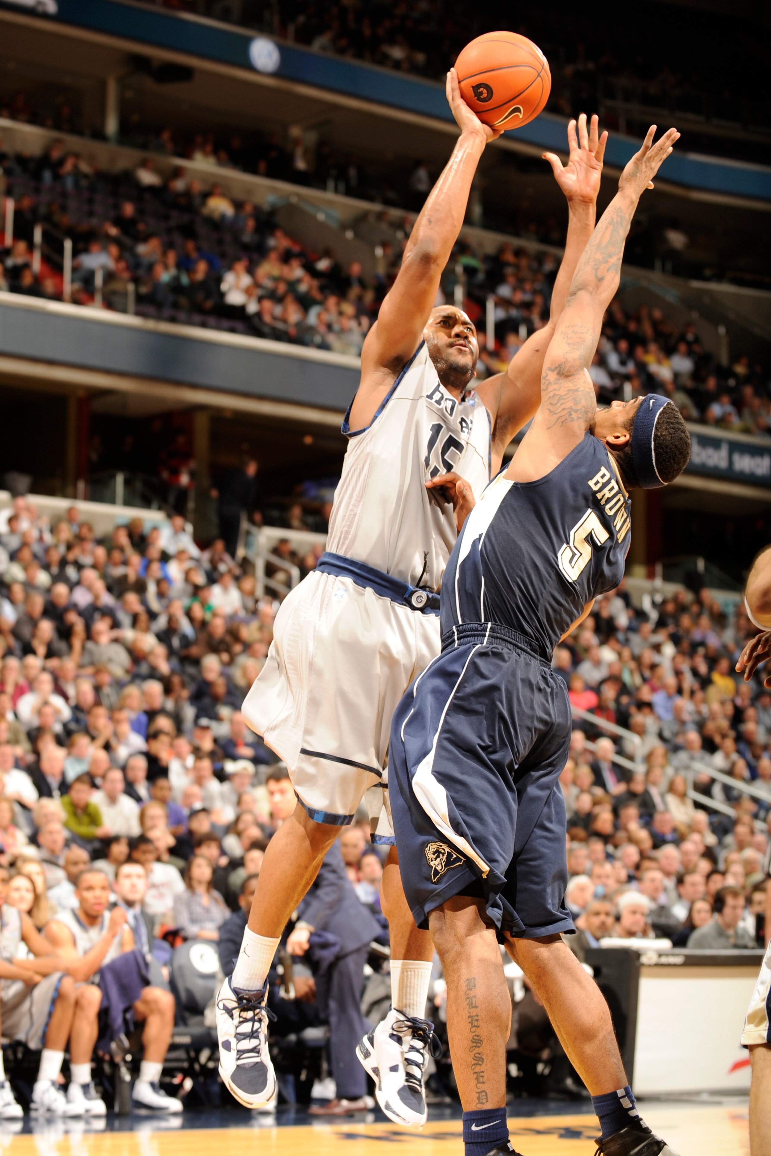 WASHINGTON, DC- JANUARY 12:  Austin Freeman #15 of the Georgetown Hoyas drives to the basket during a college basketball game against  Gilbert Brown #5 ofthe Pittsburgh Panthers on January 12, 2011 at the Verizon Center in Washington, DC.   The Panthers w