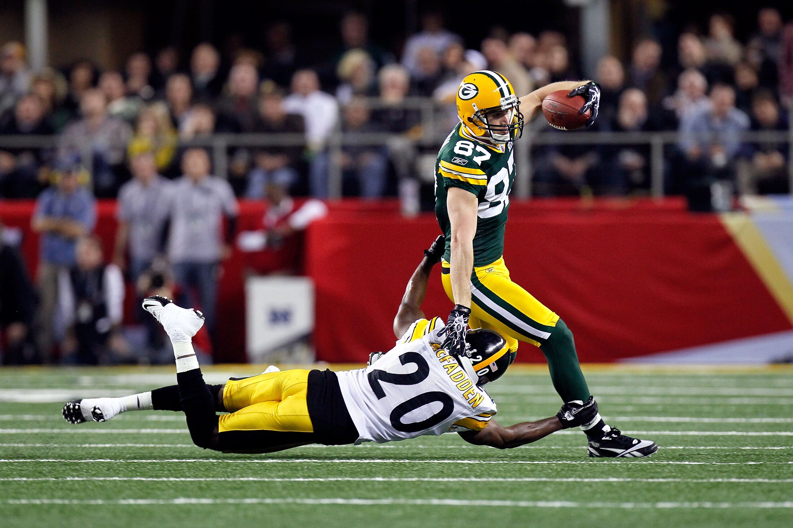ARLINGTON, TX - FEBRUARY 06:  Jordy Nelson #87 of the Green Bay Packers runs for yards after the catch against Bryant McFadden #20 of the Pittsburgh Steelers during Super Bowl XLV at Cowboys Stadium on February 6, 2011 in Arlington, Texas.  (Photo by Kevi