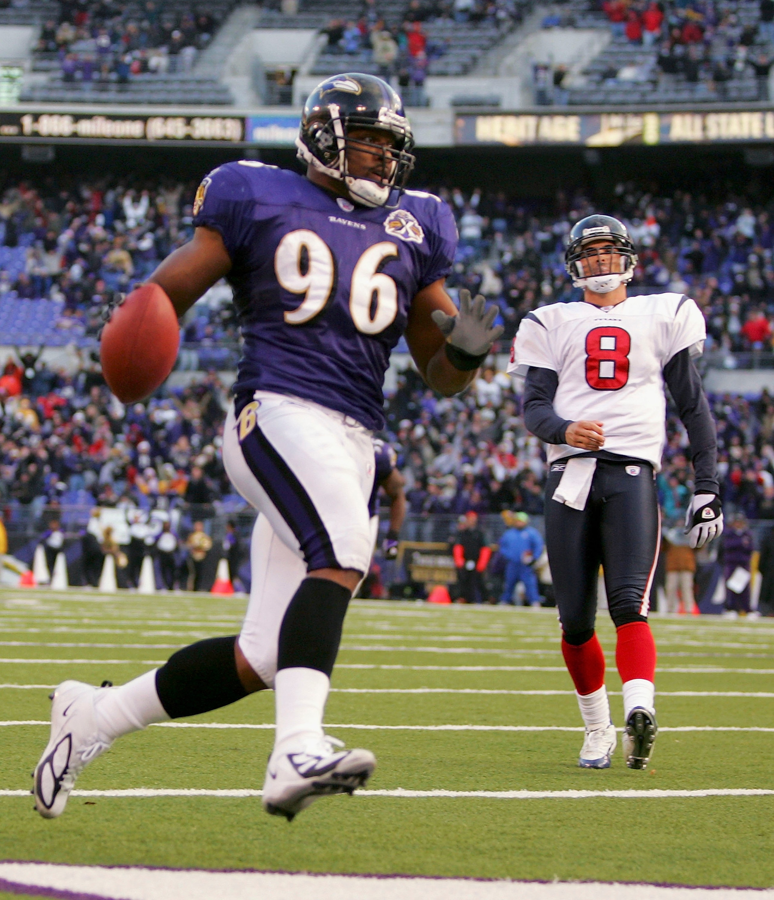 BALTIMORE - DECEMBER 04:  Quarterback David Carr #8 of the Houston Texans looks on as Adalius Thomas #96 of the Baltimore Ravens returns an interception for a touchdown during the second half of the game on December 4, 2005 at M&T Bank Stadium in Baltimor
