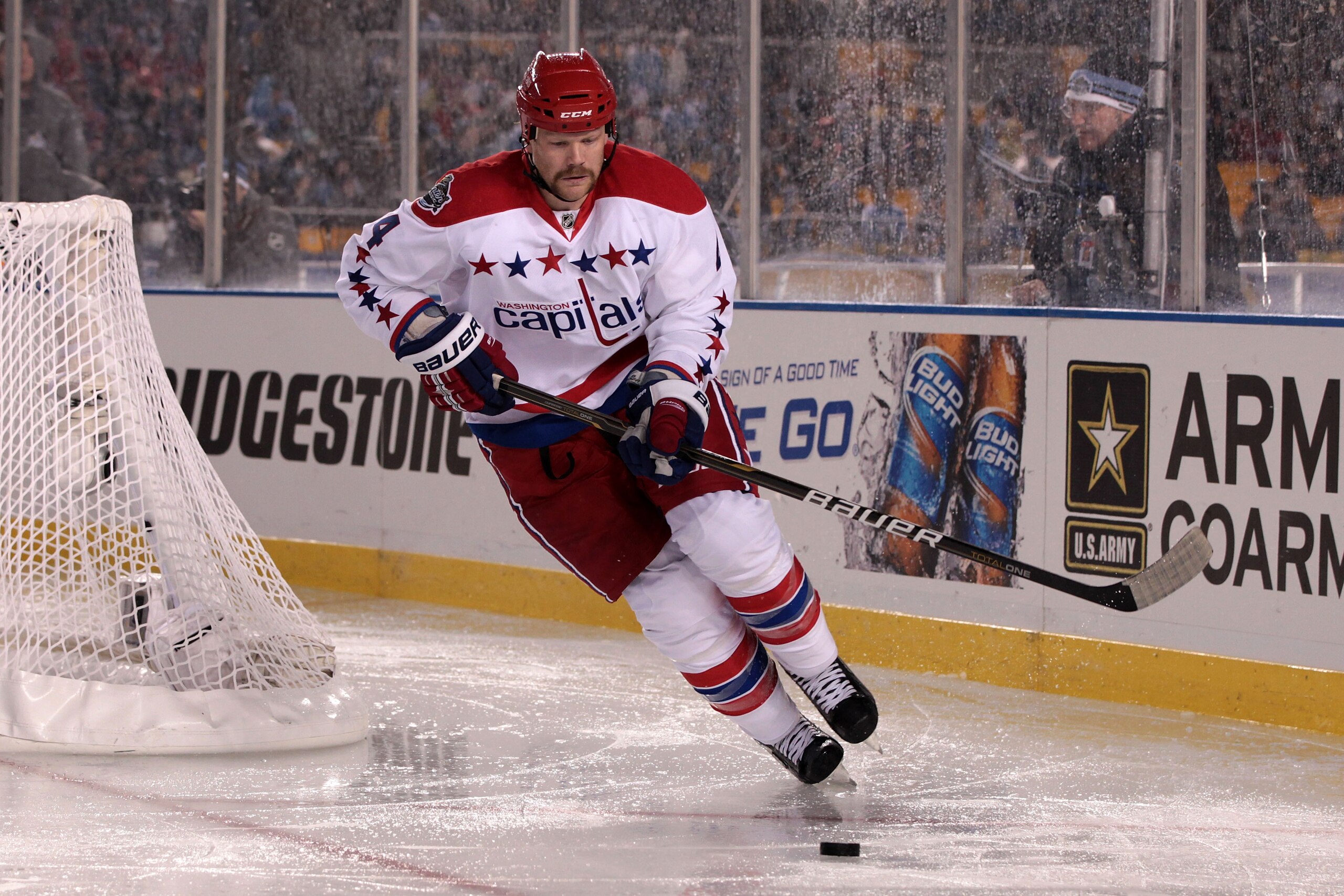 PITTSBURGH, PA - JANUARY 01:  John Erskine #4 of the Washington Capitals looks to pass against the Pittsburgh Penguins during the 2011 NHL Bridgestone Winter Classic at Heinz Field on January 1, 2011 in Pittsburgh, Pennsylvania. Washington won 3-1.  (Phot