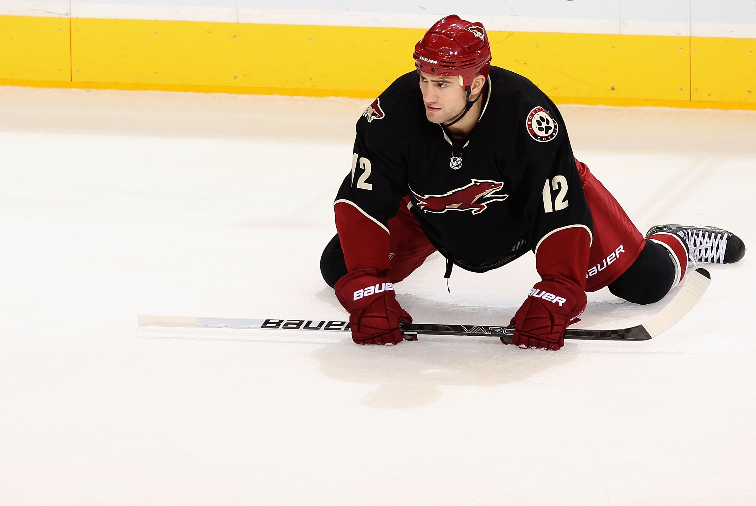 GLENDALE, AZ - JANUARY 25:  Paul Bissonnette #12 of the Phoenix Coyotes stretches on the ice during the NHL game at Jobing.com Arena on January 25, 2011 in Glendale, Arizona.  The Oilers defeated the Coyotes 4-3.  (Photo by Christian Petersen/Getty Images