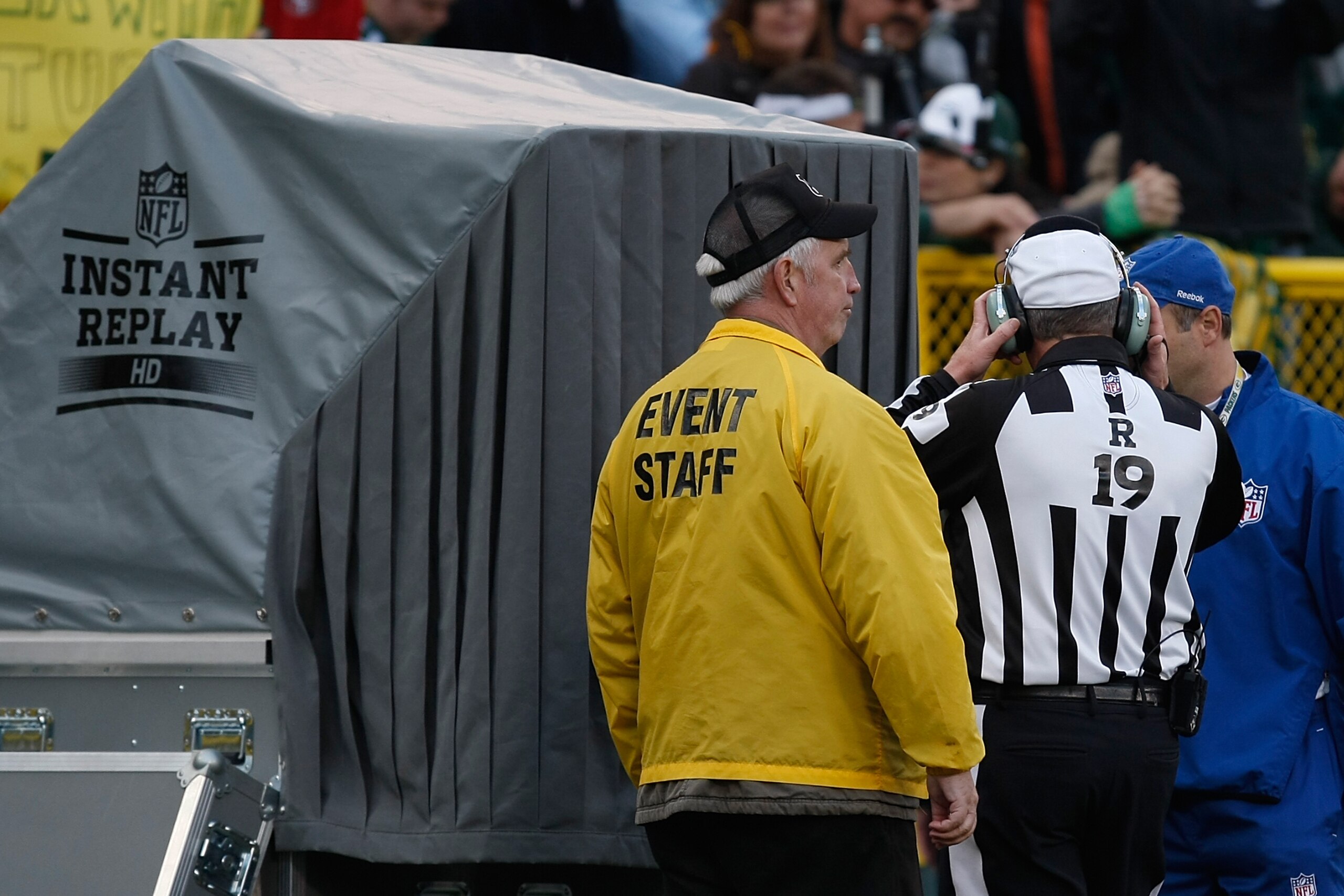 GREEN BAY, WI - NOVEMBER 22: Referee Scott Green #19 stands with head sets on at the replay booth during the game between the Green Bay Packers against the San Francisco 49ers at Lambeau Field on November 22, 2009 in Green Bay, Wisconsin. The Packers defe GREEN BAY, WI - NOVEMBER 22: Referee Scott Green #19 stands with head sets on at the replay booth during the game between the Green Bay Packers against the San Francisco 49ers at Lambeau Field on November 22, 2009 in Green Bay, Wisconsin. The Packers defe
