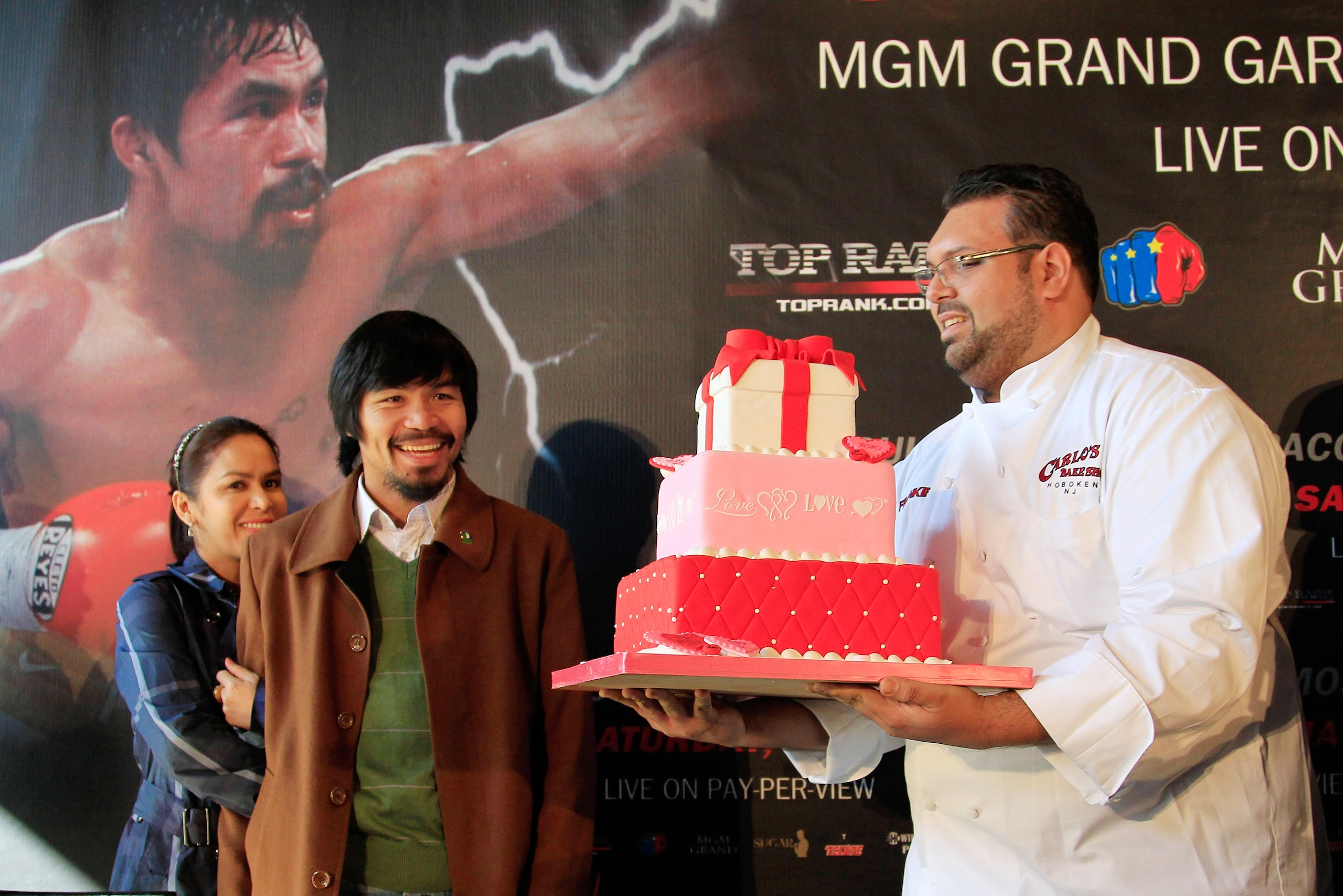NEW YORK, NY - FEBRUARY 14:  (R) Manny Pacquiao and his wife (L) Jinkee Pacquiao are presented with a Valentines Day cake at a press conference to promote his fight with Shane Mosley at The Lighthouse at Chelsea Piers on February 14, 2011 in New York City