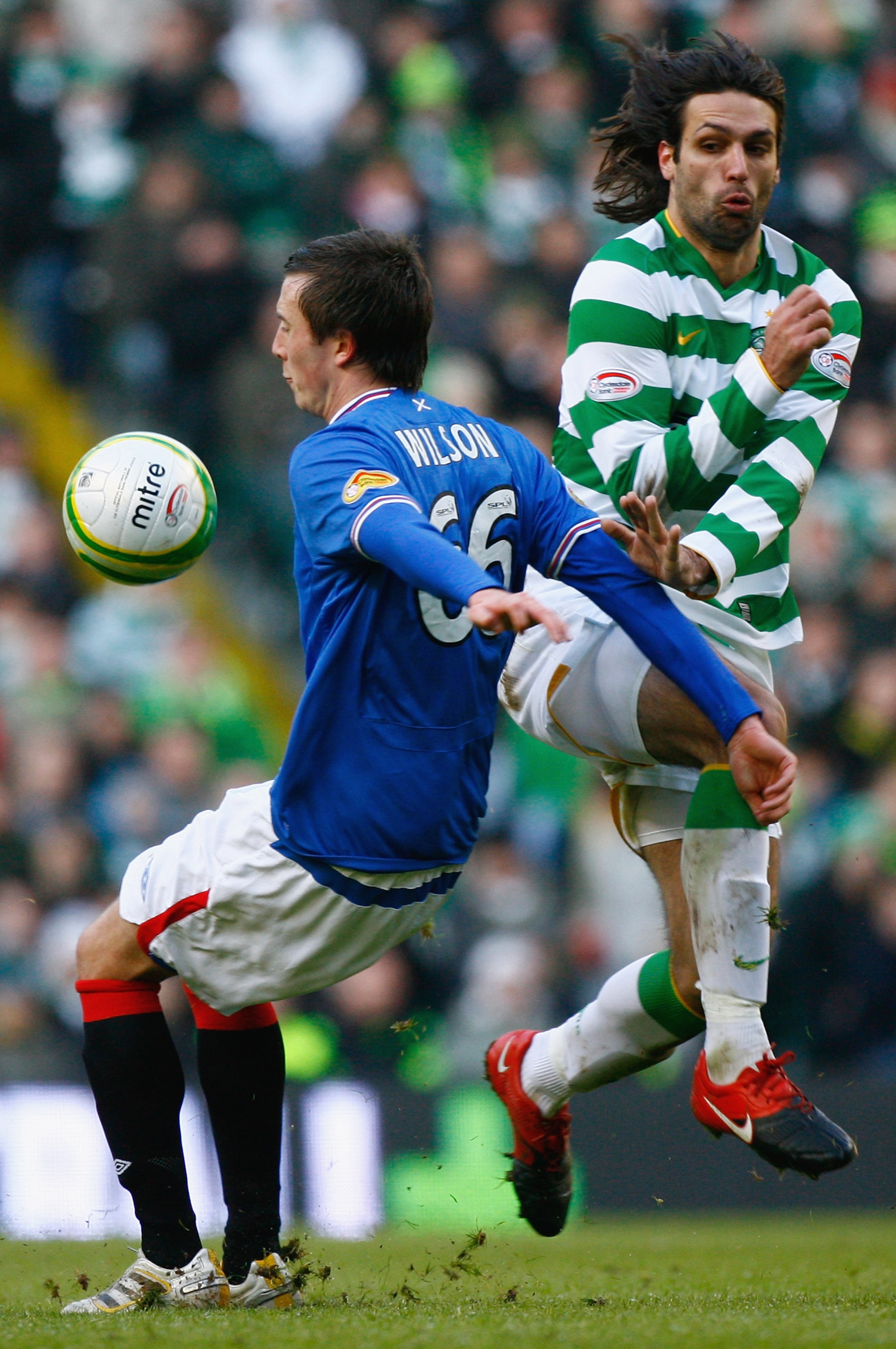 GLASGOW, SCOTLAND - JANUARY 03:  Danny Wilson of Rangers (L) is tackled by Georgios Samaras of Celtic during the Scottish Premier League match between Celtic and Rangers at Celtic Park on January 3, 2010 in Glasgow, Scotland.  (Photo by Jeff J Mitchell/Ge