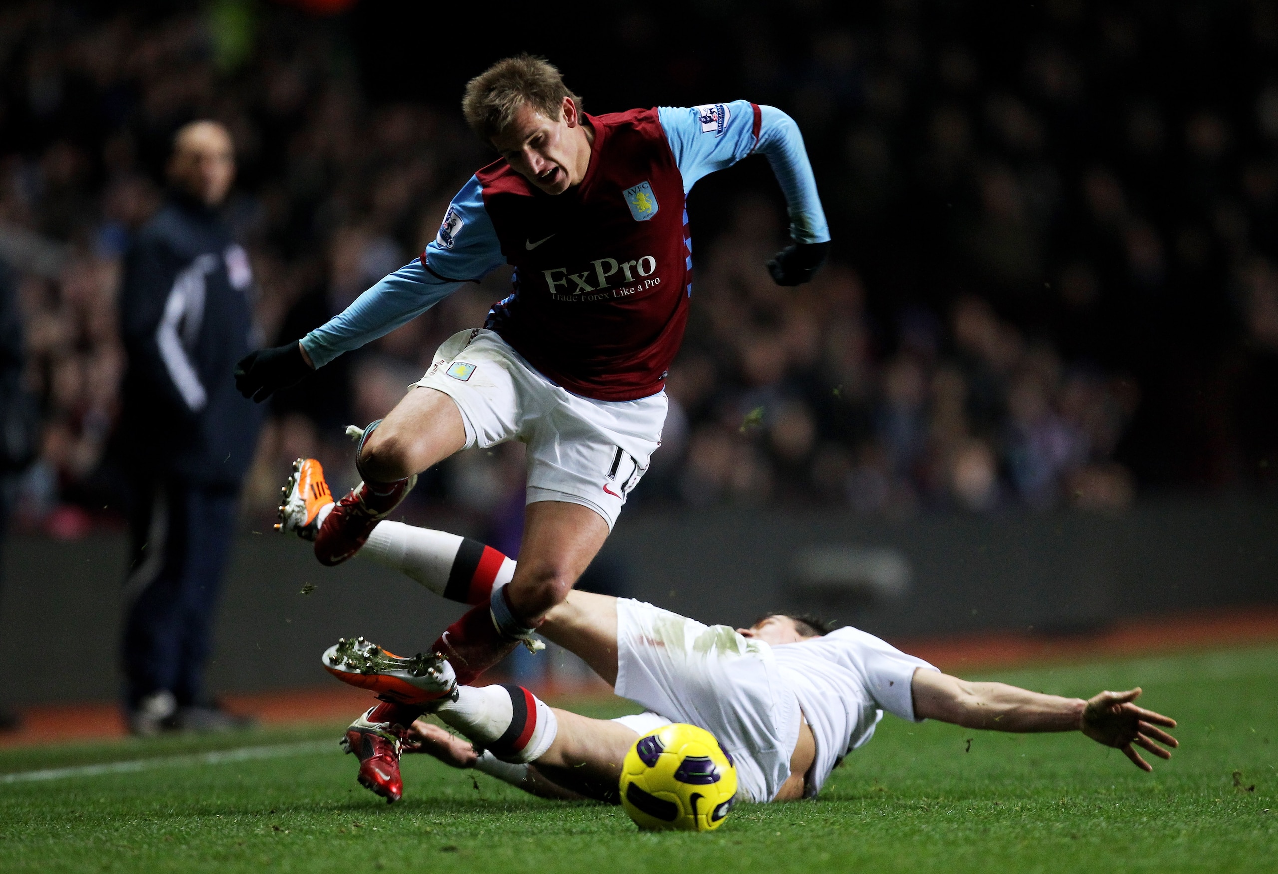 BIRMINGHAM, ENGLAND - JANUARY 22:  Marc Albrighton of Aston Villa is brought down by Aleksandar Kolarov of Manchester City during the Barclays Premier League match between Aston Villa and Manchester City at Villa Park on January 22, 2011 in Birmingham, En