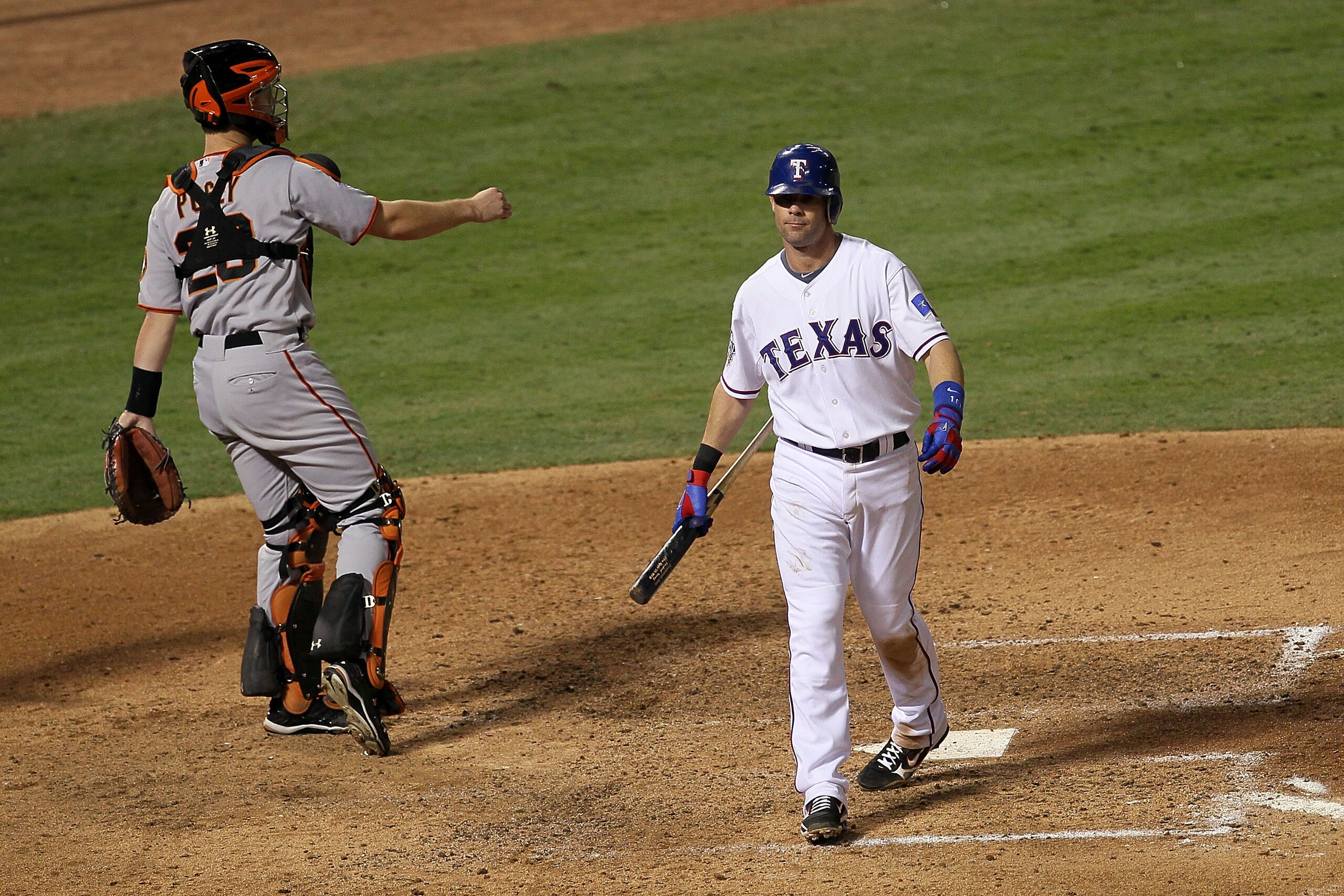 ARLINGTON, TX - OCTOBER 31: Michael Young #10 of the Texas Rangers reacts to striking out in the seventh inning against the San Francisco Giants as Buster Posey #55 throws to third in Game Four of the 2010 MLB World Series at Rangers Ballpark in Arlingto ARLINGTON, TX - OCTOBER 31: Michael Young #10 of the Texas Rangers reacts to striking out in the seventh inning against the San Francisco Giants as Buster Posey #55 throws to third in Game Four of the 2010 MLB World Series at Rangers Ballpark in Arlingto