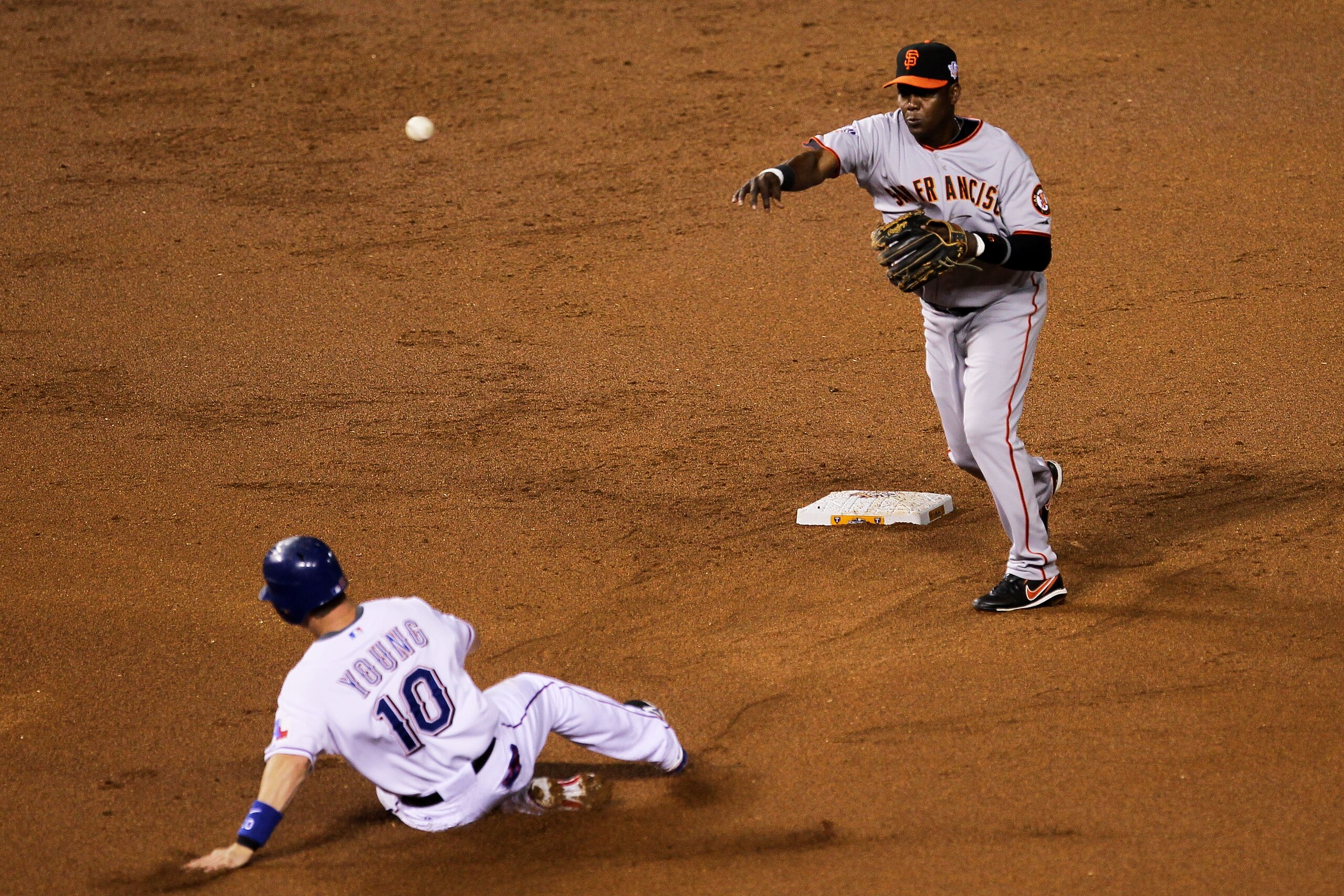 ARLINGTON, TX - OCTOBER 31: Edgar Renteria #16 of the San Francisco Giants turns a successful double play over a sliding Michael Young #10 of the Texas Rangers on a ball hit by Josh Hamilton #32 in the bottom of the first inning of Game Four of the 2010 ARLINGTON, TX - OCTOBER 31: Edgar Renteria #16 of the San Francisco Giants turns a successful double play over a sliding Michael Young #10 of the Texas Rangers on a ball hit by Josh Hamilton #32 in the bottom of the first inning of Game Four of the 2010