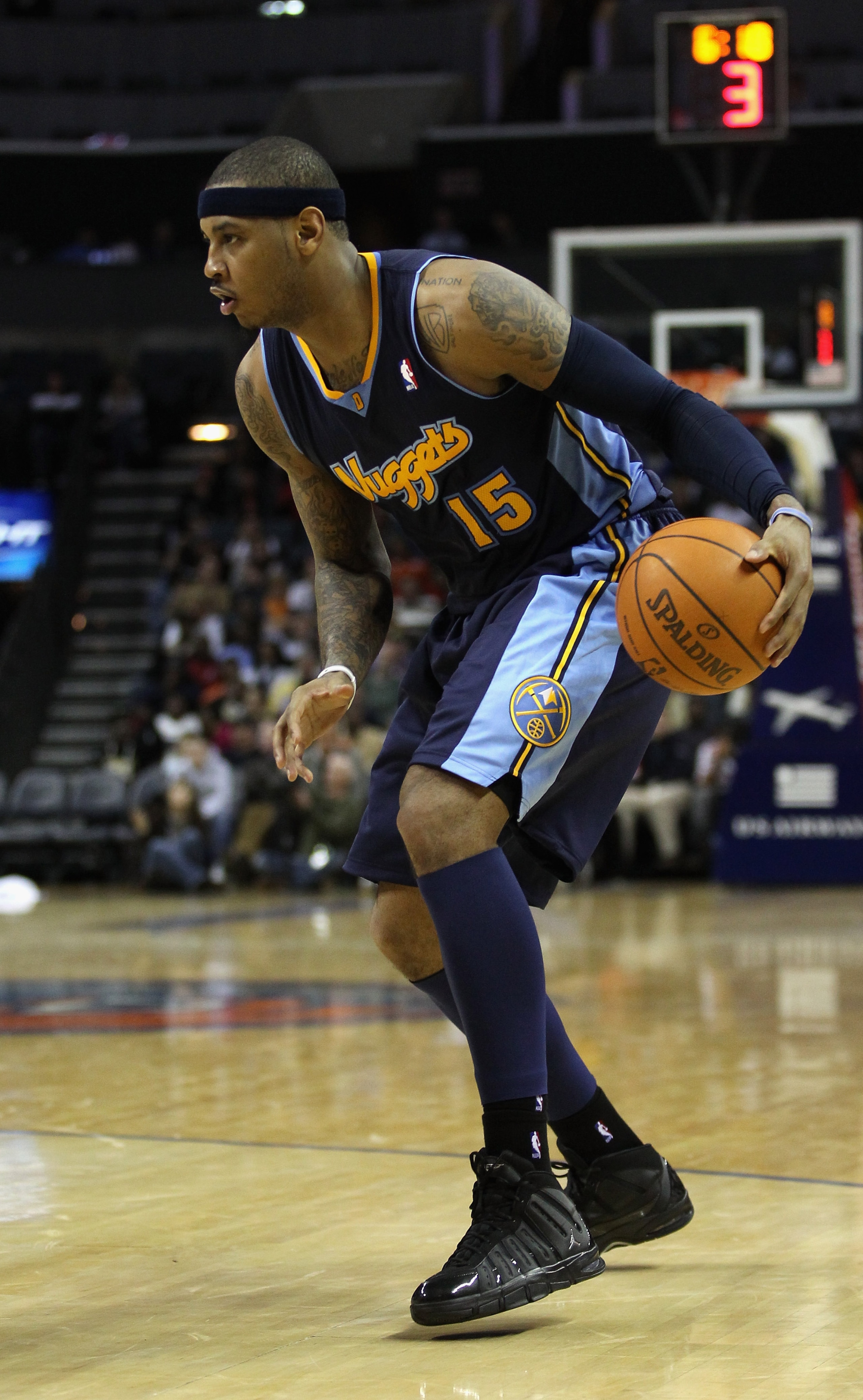 CHARLOTTE, NC - DECEMBER 07: Carmelo Anthony #15 of the Denver Nuggets watches on against the Charlotte Bobcats during their game at Time Warner Cable Arena on December 7, 2010 in Charlotte, North Carolina. NOTE TO USER: User expressly acknowledges and CHARLOTTE, NC - DECEMBER 07: Carmelo Anthony #15 of the Denver Nuggets watches on against the Charlotte Bobcats during their game at Time Warner Cable Arena on December 7, 2010 in Charlotte, North Carolina. NOTE TO USER: User expressly acknowledges and